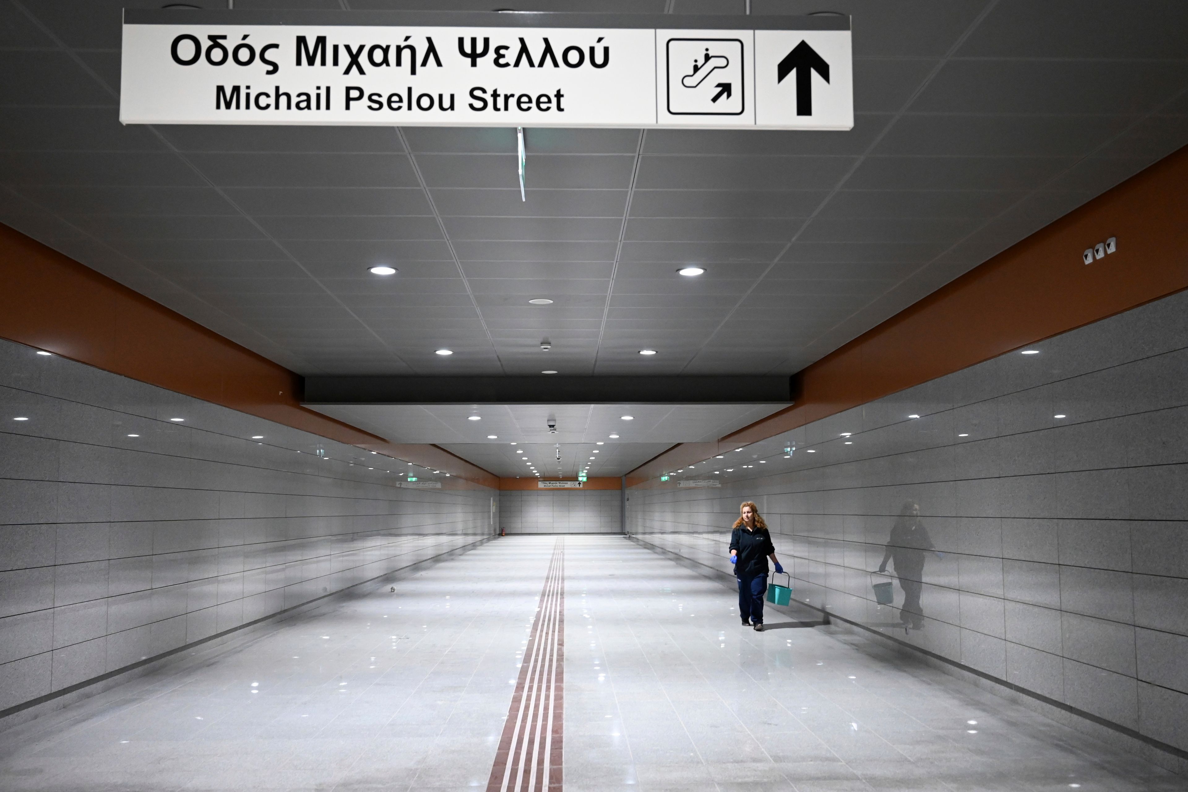 A member of the cleaning staff walks through the newly built Nea Elvetia metro station ahead of its Nov. 30 official opening, in Thessaloniki, northern Greece, Friday, Nov. 22, 2024 – part of the city's long-delayed subway system showcasing archaeological finds from decades of construction. (AP Photo/Giannis Papanikos)