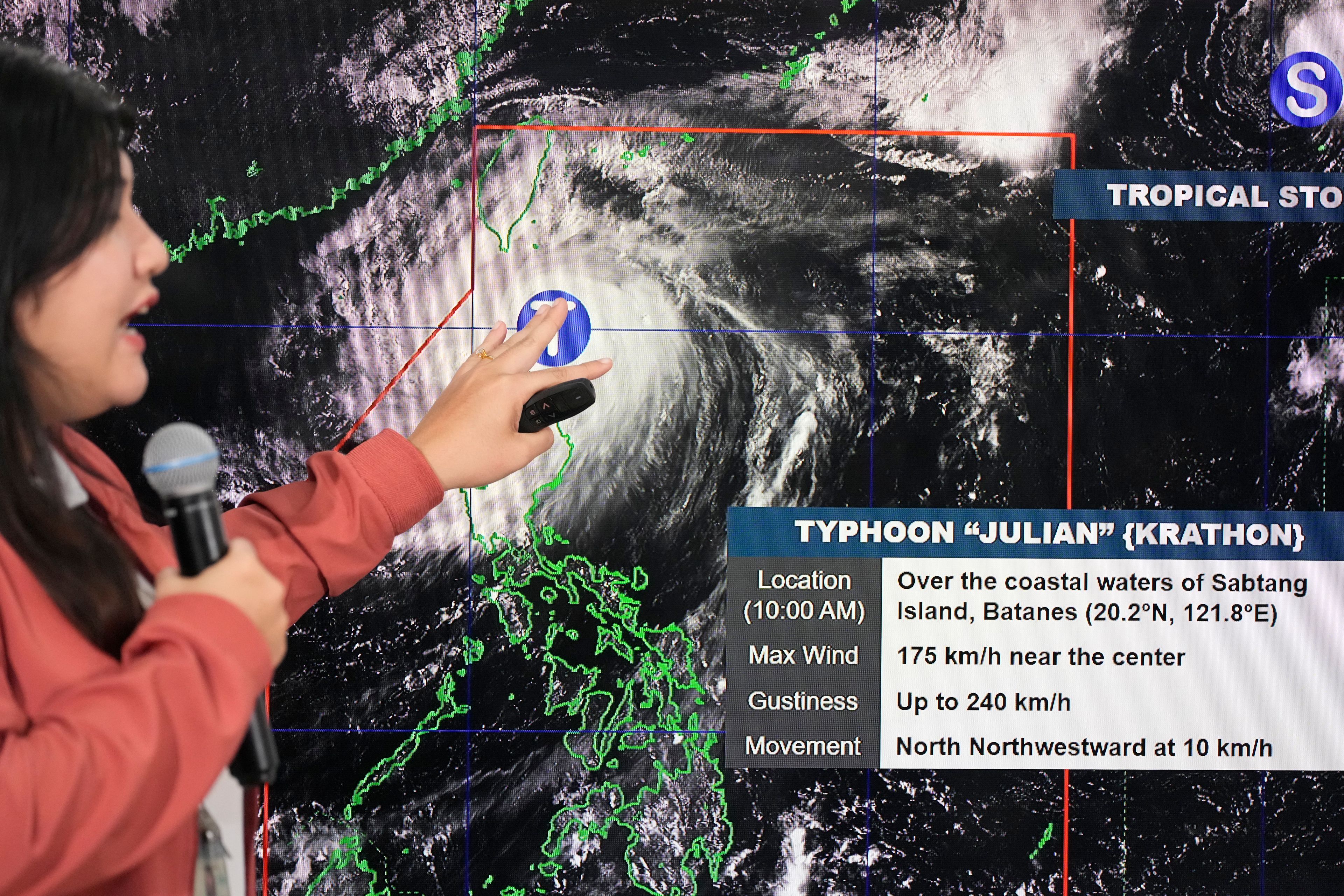 Philippine Atmospheric, Geophysical and Astronomical Services Administration weather specialist Veronica Torres points at an electronic board to show the strength of powerful Typhoon Krathon on Monday, Sept. 30, 2024, in Quezon city, Philippines as it is projected to go towards Taiwan the next day after hitting northern Philippines. (AP Photo/Aaron Favila)