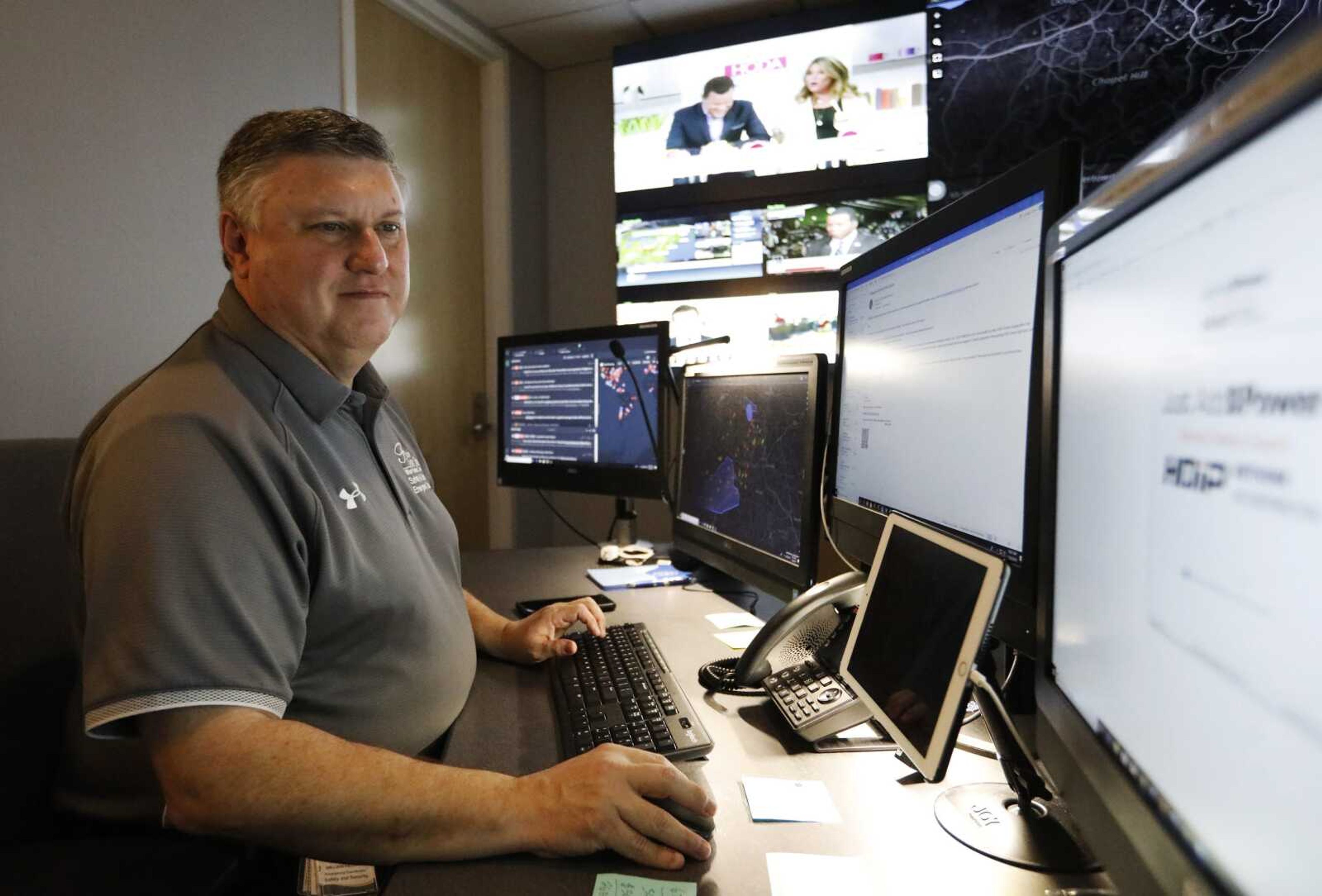 Paul Hildreth, emergency operations coordinator for the Fulton County School District, works in the emergency operations center at the Fulton County School District Administration Center in Atlanta. Artificial intelligence is transforming surveillance cameras from passive sentries into active observers capable of immediately spotting a gunman, alerting retailers when someone is shoplifting and helping police quickly find suspects.