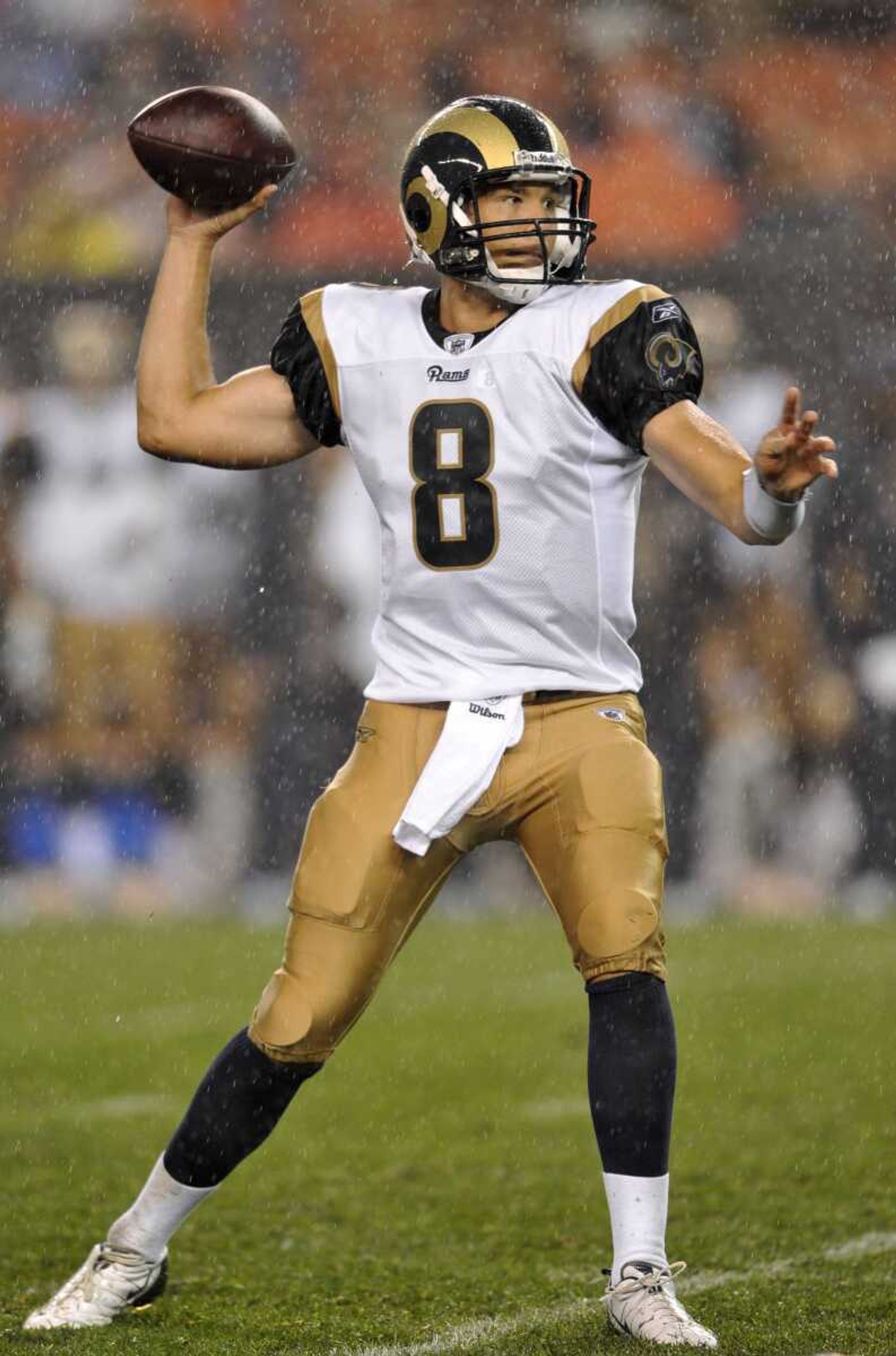 Rams quarterback Sam Bradford passes in the rain during Saturday's preseason game against the Browns. Bradford was 6 of 14 passing for 24 yards. The Rams won 19-17. (David Richard ~ Associated Press)