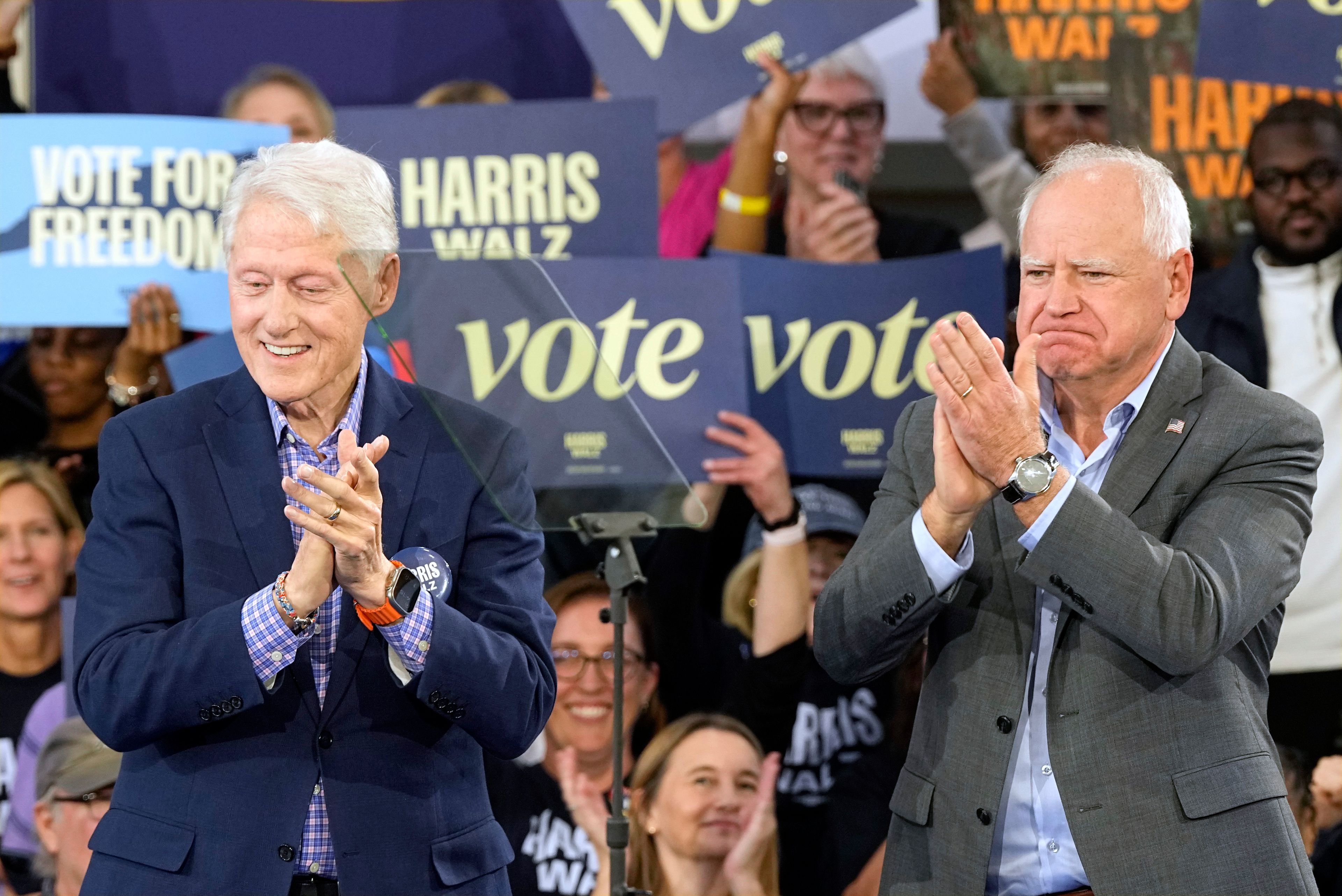 Democratic vice presidential nominee Minnesota Gov. Tim Walz, appears with former President Bill Clinton at a campaign rally in Durham, N.C., Thursday, Oct. 17, 2024. (AP Photo/Steve Helber)