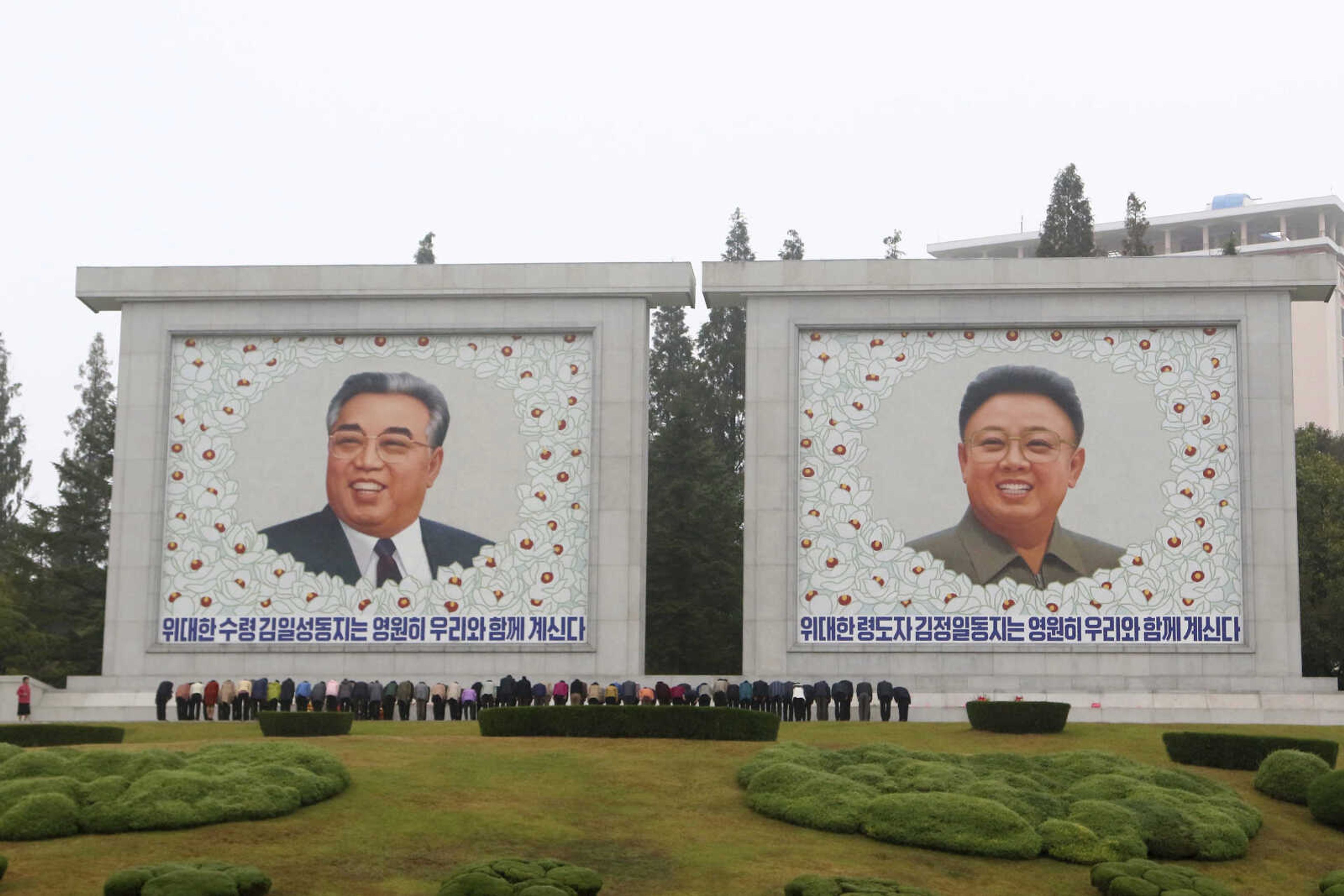 FILE - Citizens visit the portraits of the country's late leaders Kim Il Sung and Kim Jong Il on the occasion of the 78th founding anniversary of the Worker's Party of Korea in Pyongyang, North Korea, Oct. 10, 2023.  The White House says that North Korea has delivered more than 1,000 containers of military equipment and munitions to Russia for its ongoing war in Ukraine. White House National Security Council spokesman John Kirby said Friday the U.S. believes Kim is seeking sophisticated Russian weapons technologies in return for the munitions to boost North Korea's military. (AP Photo/Jon Chol Jin, file)