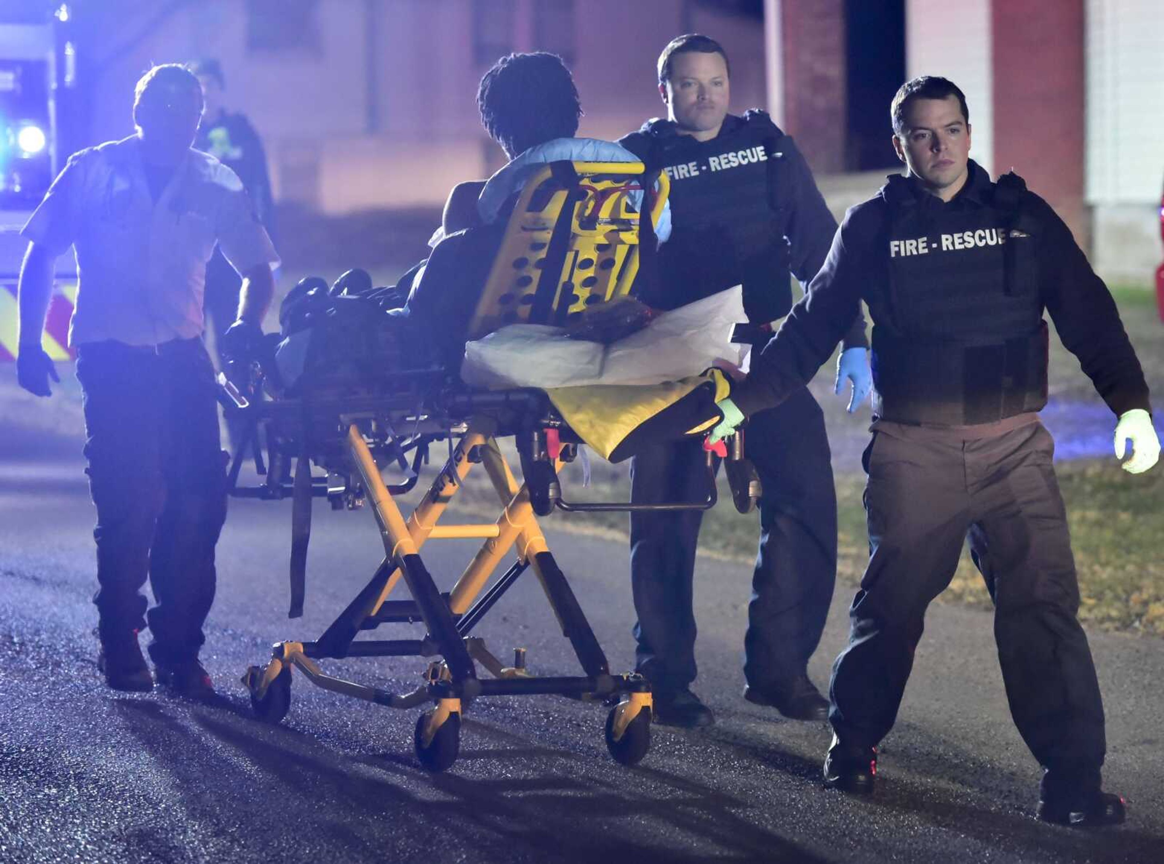 First responders wheel a gunshot victim to an ambulance Saturday at 1003 S. Pacific St. in Cape Girardeau. Two victims were taken from the scene.