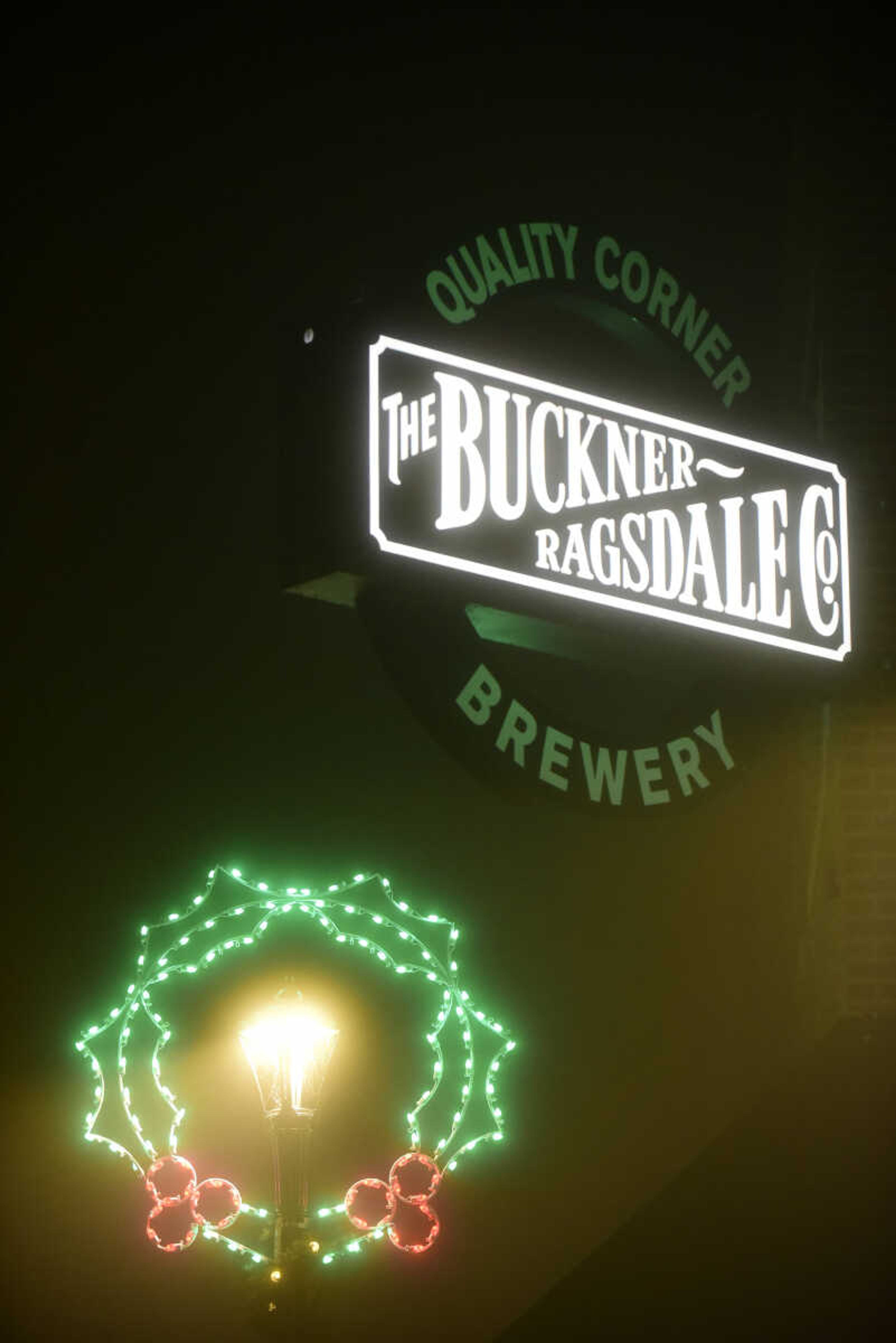 A holiday light wreath next to The Buckner Ragsdale sign Wednesday, Nov. 15, 2017 in downtown Cape Girardeau.