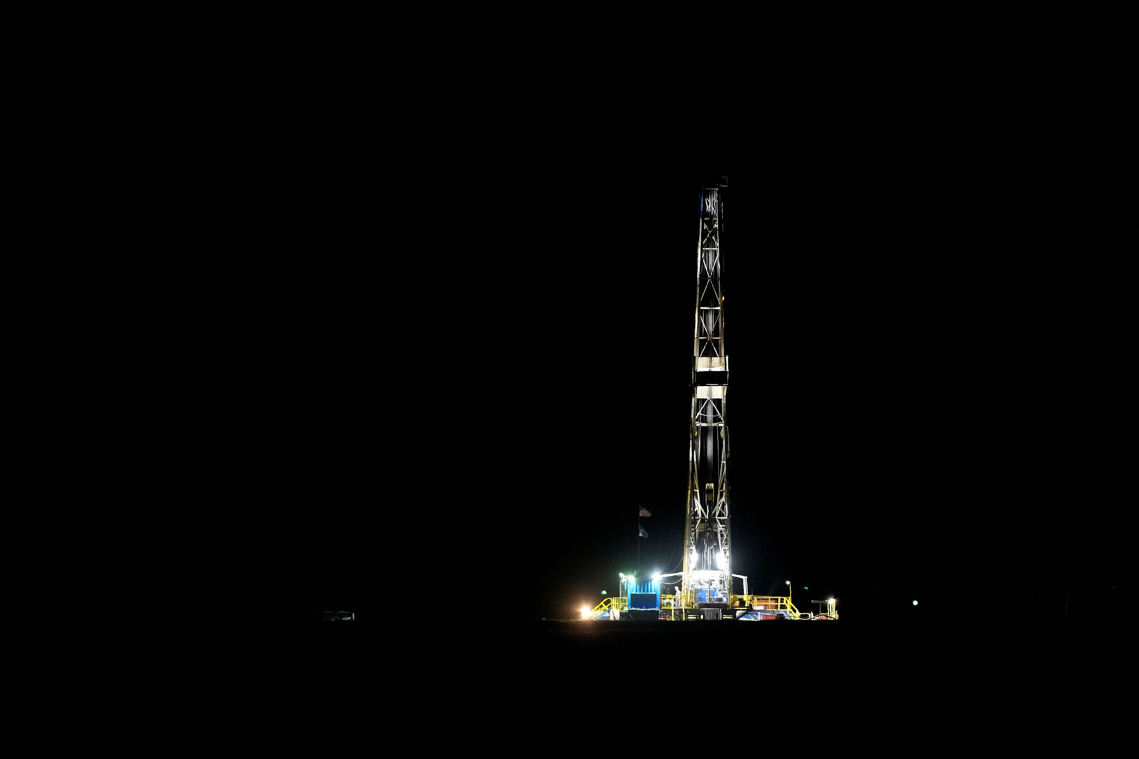 An oil rig operates, Sunday, Sept. 29, 2024, near Garfield, Kan. (AP Photo/Charlie Riedel)