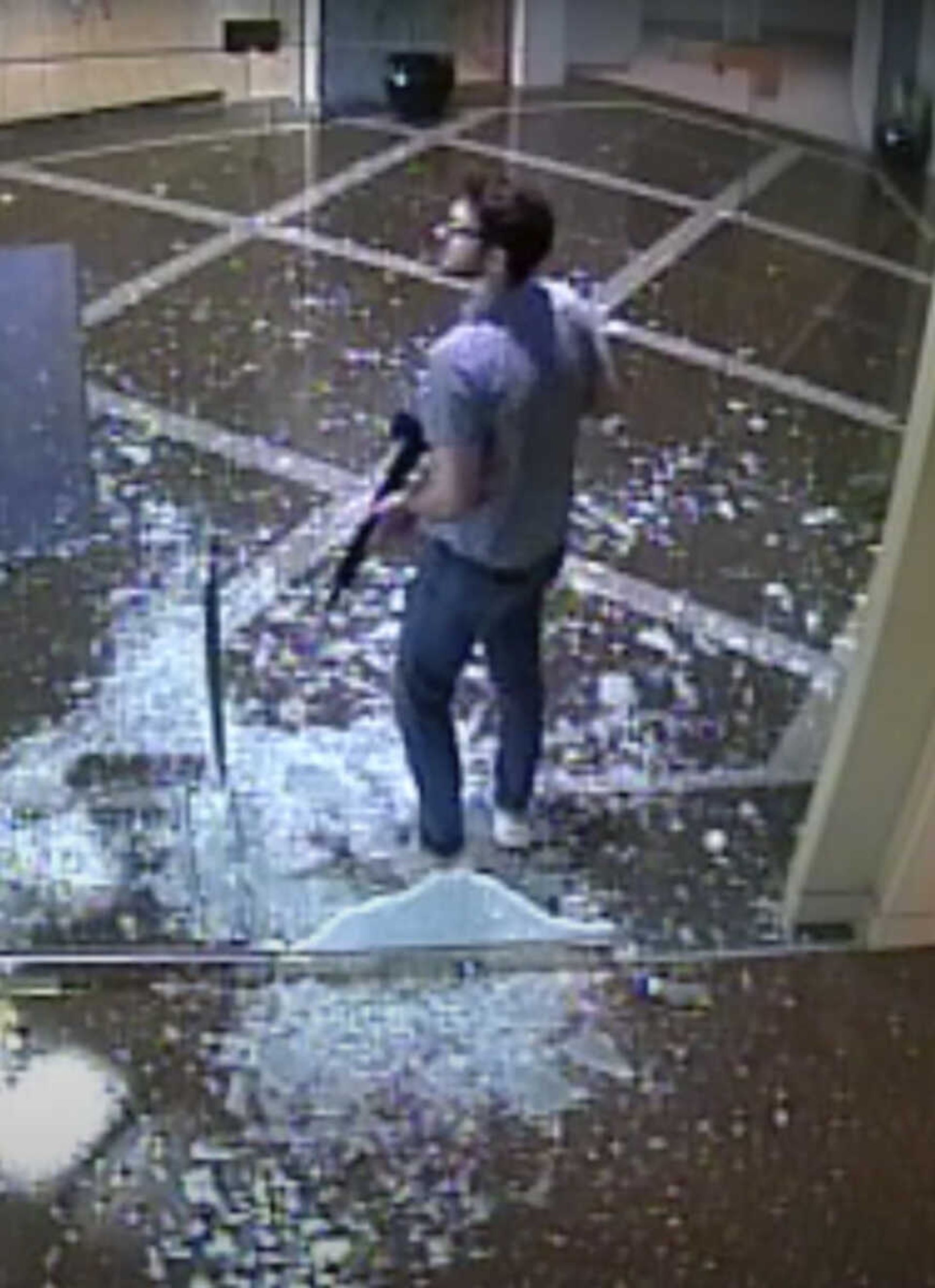 This surveillance video shows bank employee Connor Sturgeon, 25, carrying an AR-15 assault-style rifle after opening fire Monday at Old National Bank in Louisville, Kentucky.