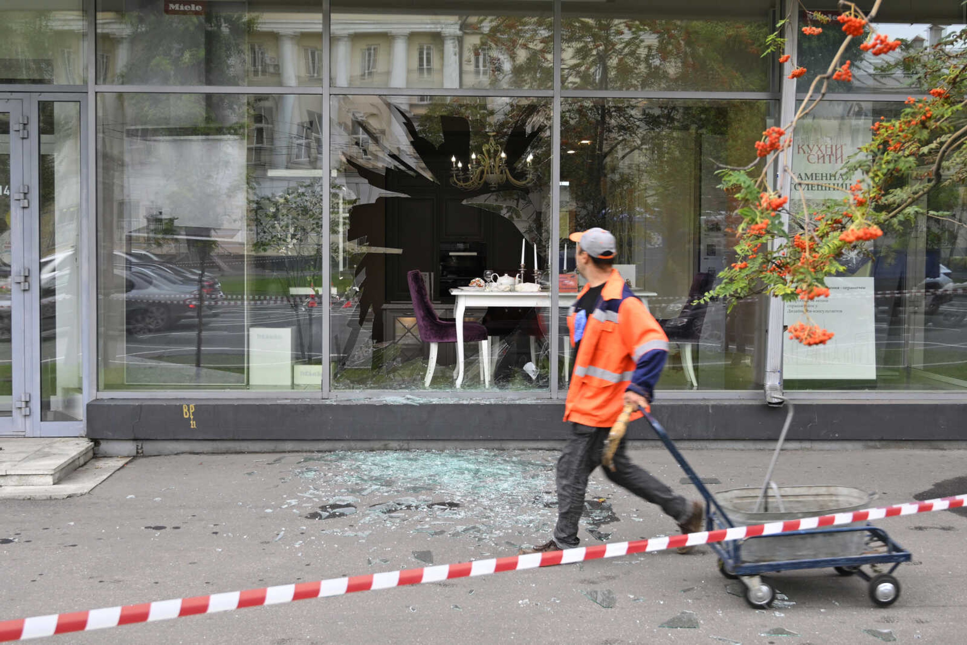 A man walks past a damaged building after a reported drone attack Monday in Moscow.