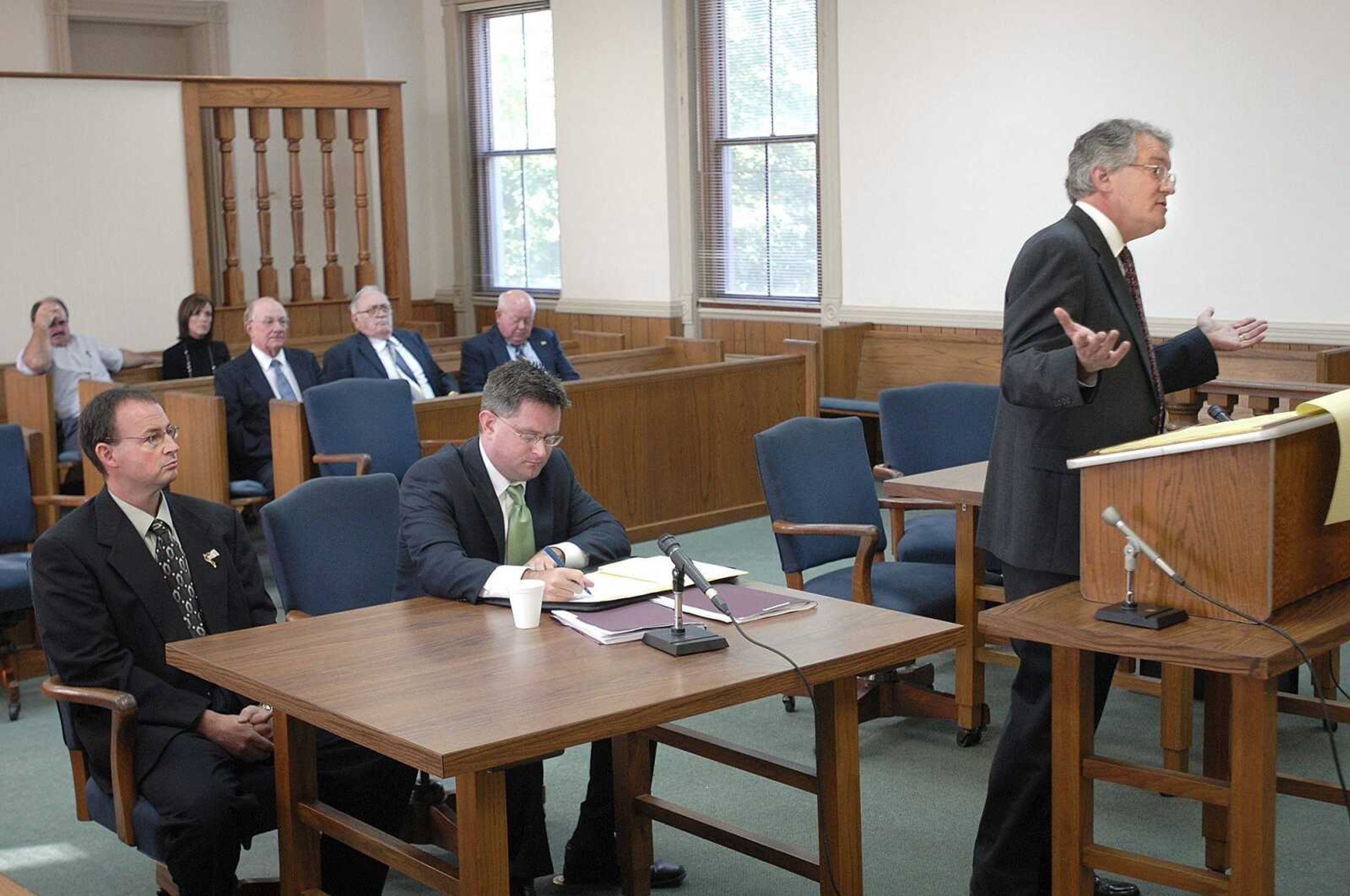 Attorney Tom Ludwig speaks for the Cape Girardeau County Commission at an October hearing before Judge Stephen Mitchell in the Common Pleas Courthouse in Cape Girardeau. County Commissioner Jay Purcell, left, and his attorney, J.P Clubb, listen. (Fred Lynch)