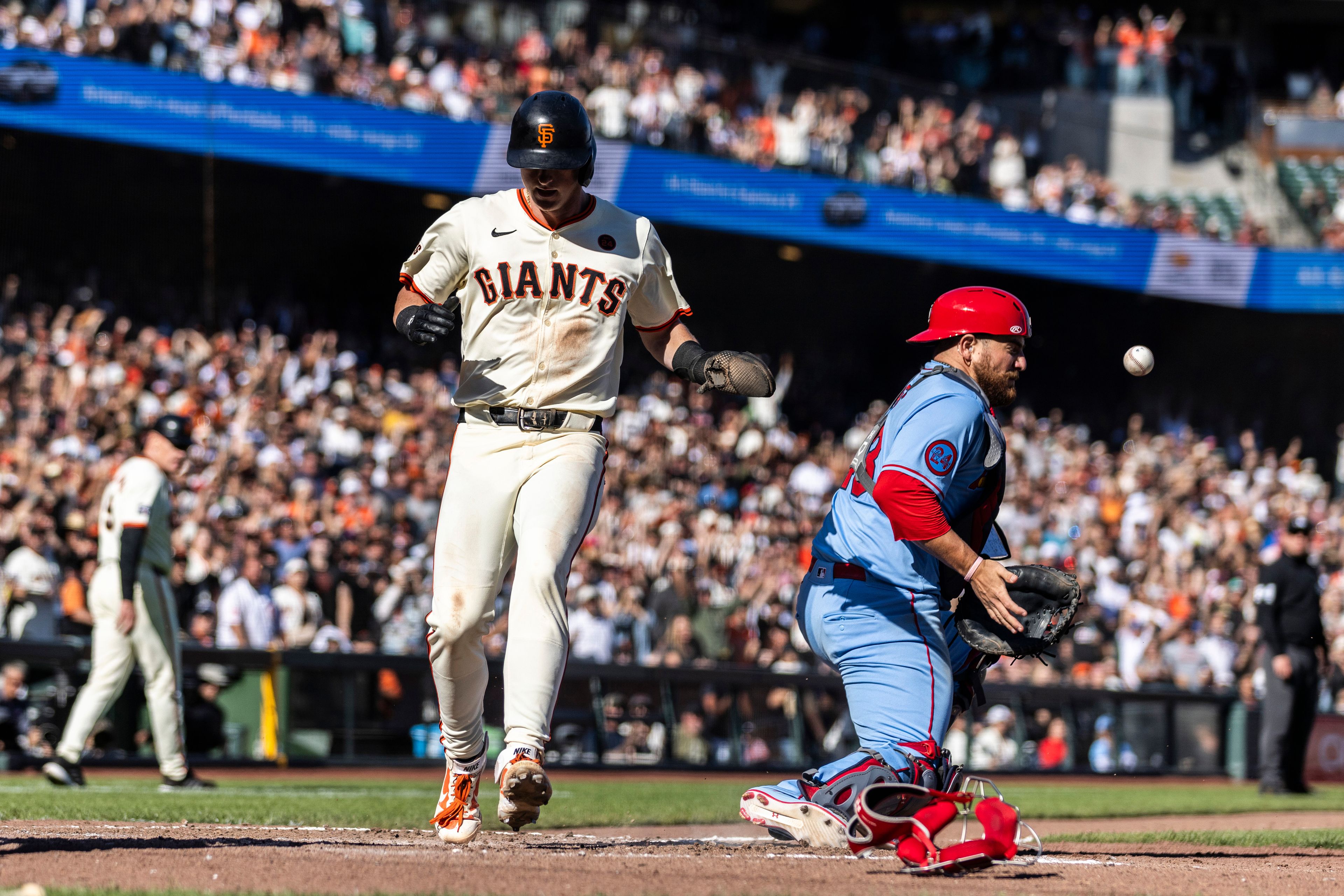 San Francisco Giants' Tyler Fitzgerald (49) scores the game-winning run on a throwing error by St. Louis Cardinals pitcher Matthew Liberatore (52) during the eighth inning of a baseball game in San Francisco, Saturday, Sept. 28, 2024. (Stephen Lam/San Francisco Chronicle via AP)