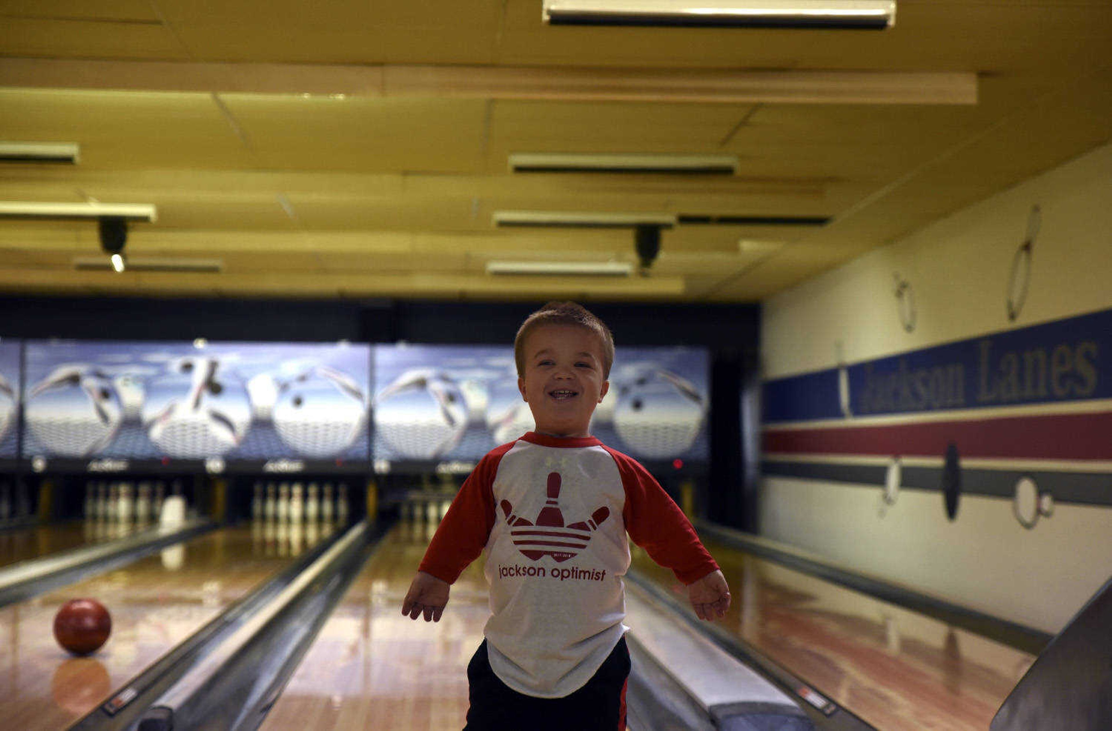 Izaac Pursley smiles as he returns to his seat after making a strike while bowling at Jackson Lanes March 19, 2018, in Jackson