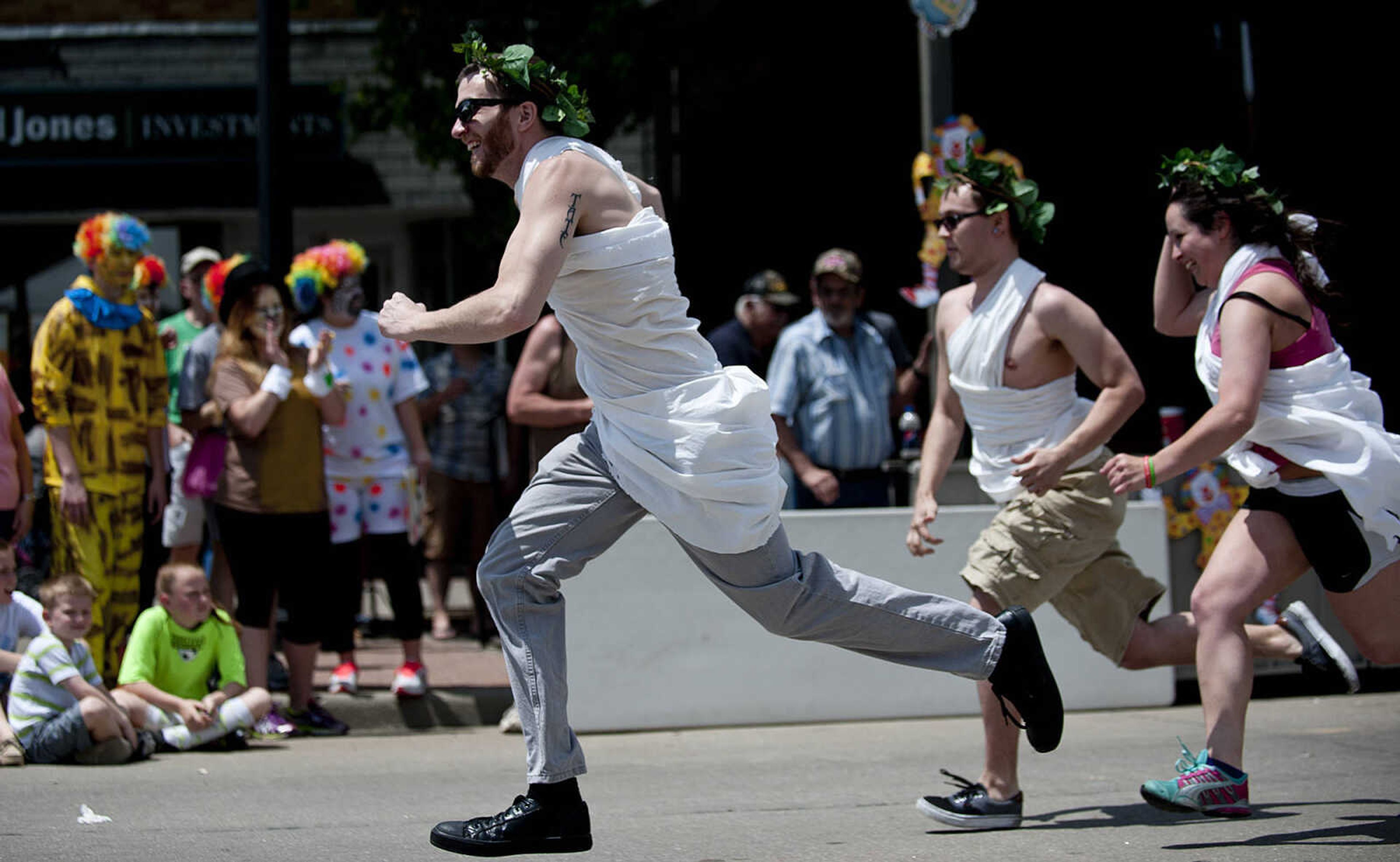 Taylor Old, left, Michael Horn and Ashley Reid race for the finish line as the Animal House team sponsored by Mary Jane, Burgers and Brew, compete in the Perryville Mayfest Bed Races Saturday, May 10, in Perryville, Mo.