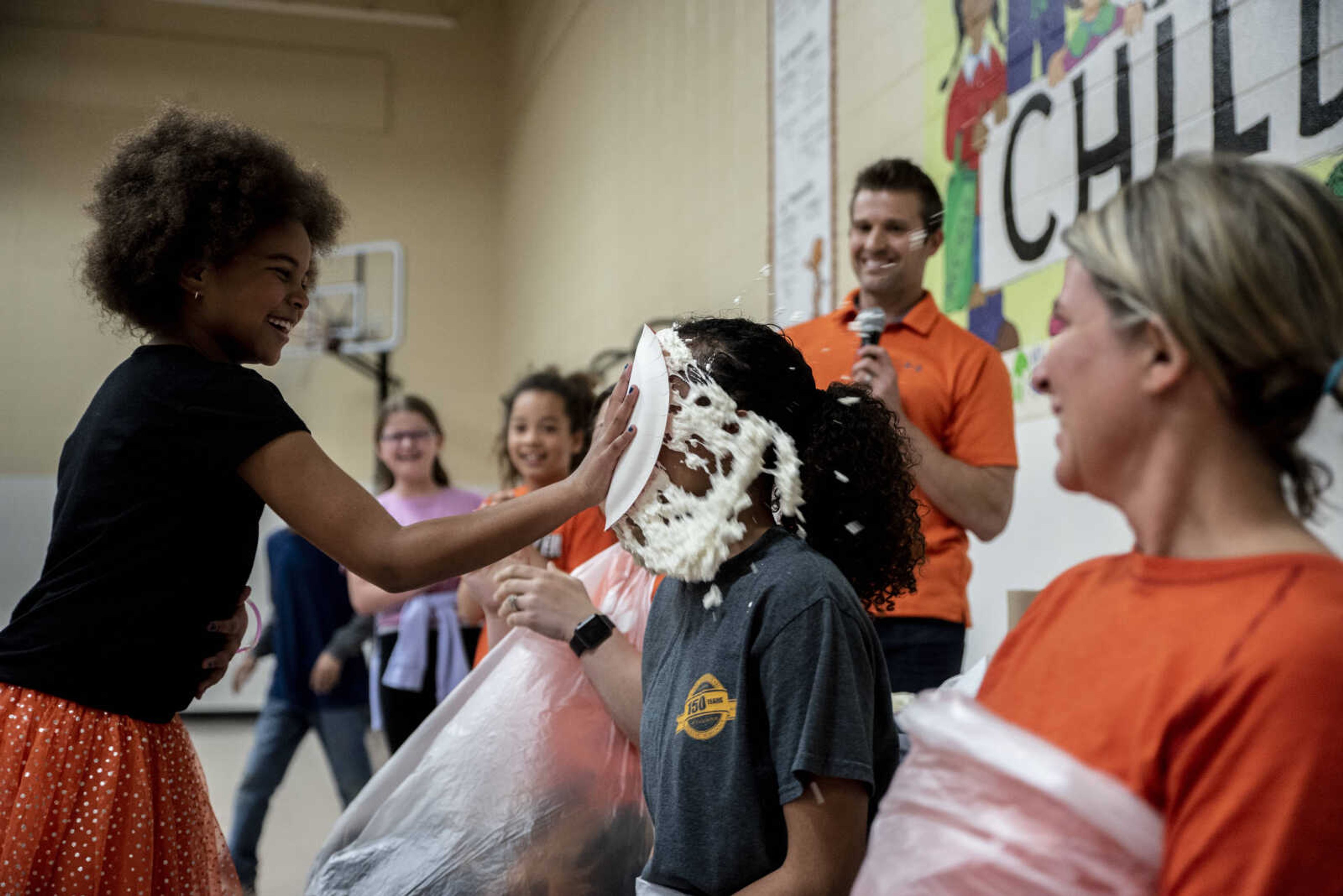 Second grader Kayden Kirn pies Charity Owens in the face at Clippard Elementary School Friday, April 5, 2019, in Cape Girardeau. Students earned votes for which teacher(s) would get pied in the face when they brought in donations to raise money for their end-of-the-year play day that is free to students. Through students and other donations, the school raised $550 towards their play day activities.