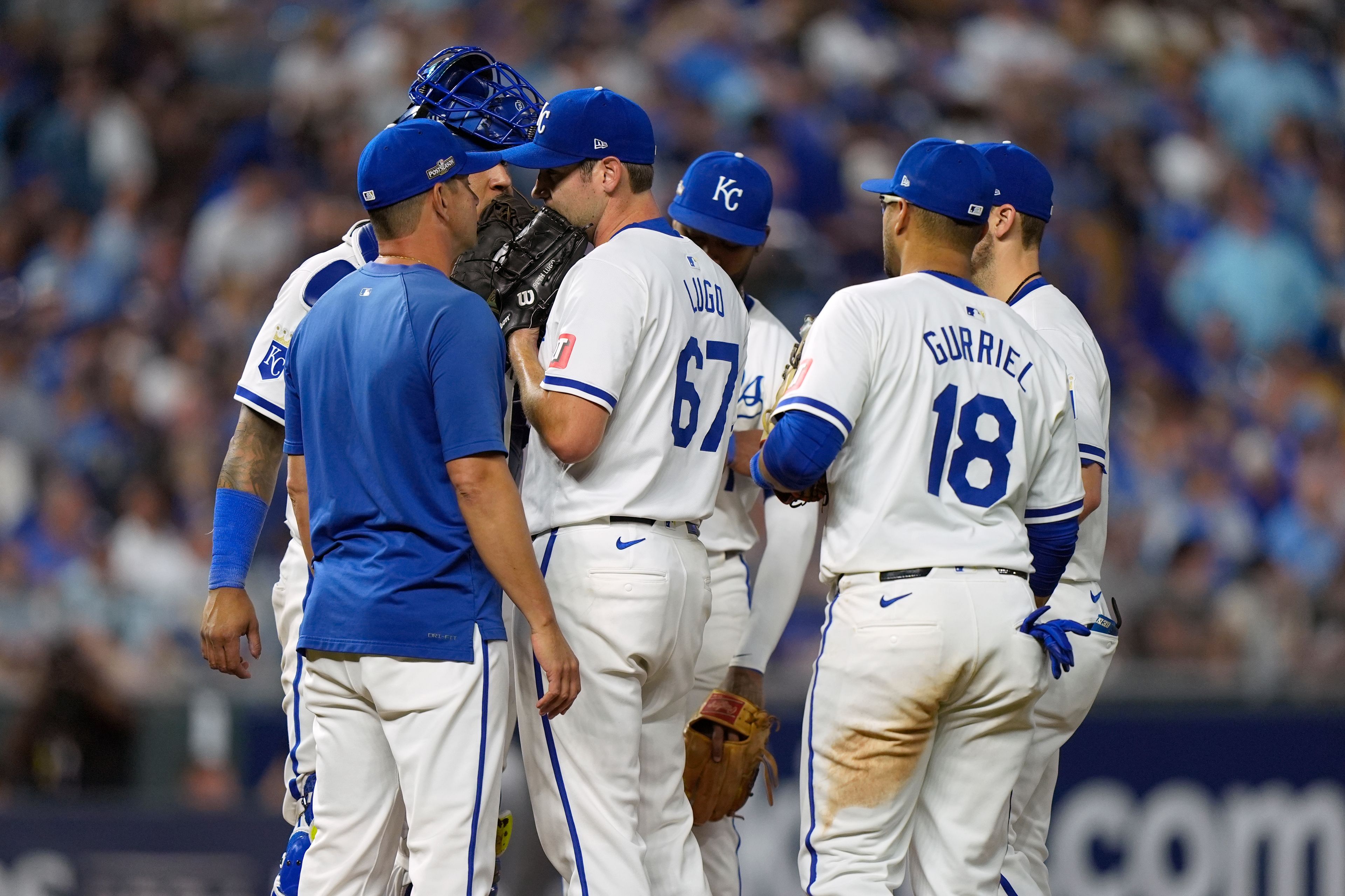 Kansas City Royals starting pitcher Seth Lugo (67) talks with Royals pitching coach Brian Sweeney, left, during the fifth inning in Game 3 of an American League Division baseball playoff series against the New York Yankees Wednesday, Oct. 9, 2024, in Kansas City, Mo. (AP Photo/Charlie Riedel)