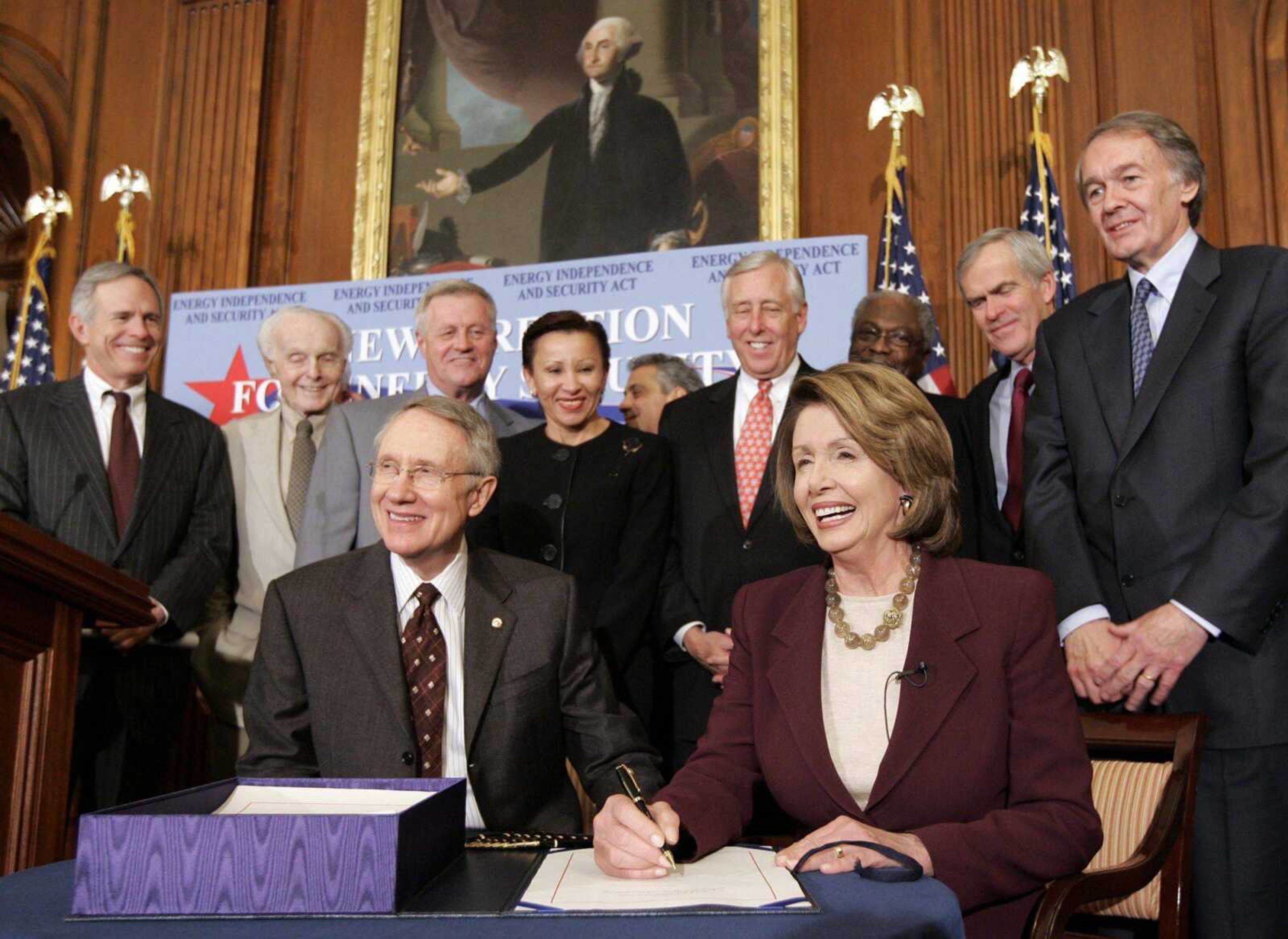 House Speaker Nancy Pelosi of California, seated, right, accompanied by Senate Majority Leader Harry Reid of Nevada, seated, left, and others, smiled Tuesday as she signed the Energy Independence and Security Act on Capitol Hill in Washington. Standing, from left, were Rep. Bart Gordon, D-Tenn., Rep. Tom Lantos, D-Calif., Rep. Collin Peterson, D-Minn., Rep. Nydia Velazquez, D-N.Y., Rep. Rahm Emanuel, D-Ill., House Majority Leader Steny Hoyer of Maryland, House Majority Whip James Clyburn of South Carolina, Sen. Jeff Bingaman, D-N.M., and Rep. Edward Markey, D-Mass. (Susan Walsh ~ Associated Press)