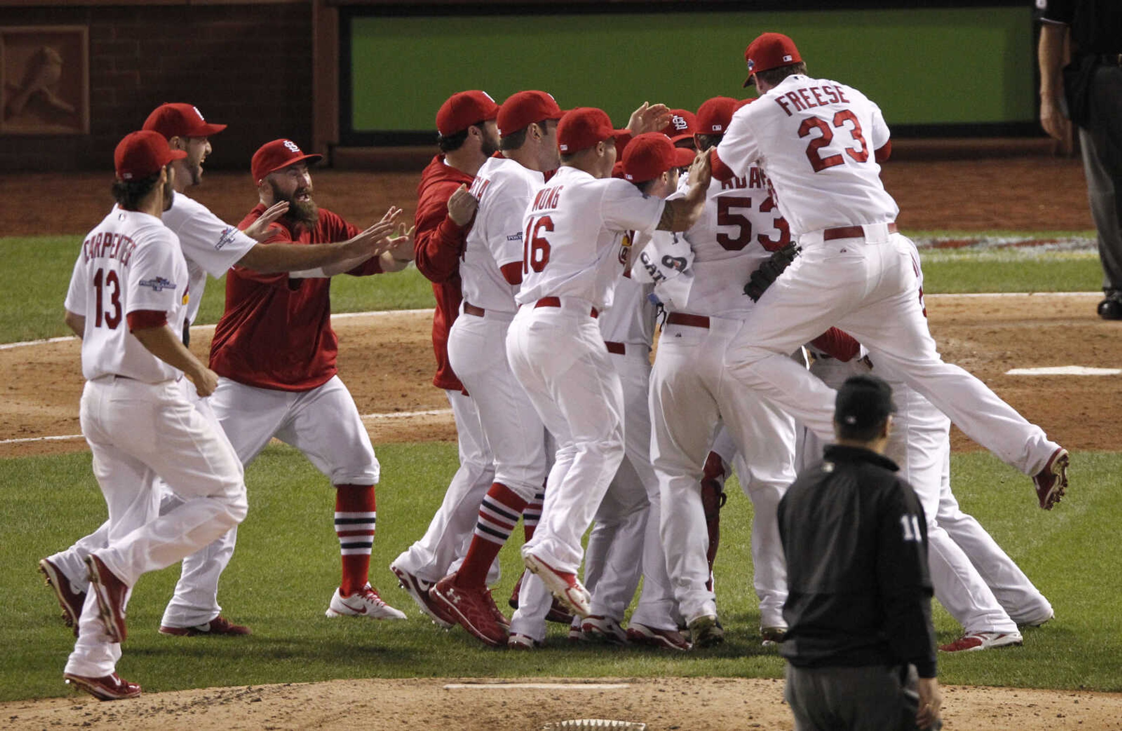 The St. Louis Cardinals celebrate after beating the Pittsburgh Pirates 6-1 in Game 5 of a National League baseball division series, Wednesday, Oct. 9, 2013, in St. Louis. The Cardinals advanced to the NL championship series against the Los Angeles Dodgers. (AP Photo/Sarah Conard)