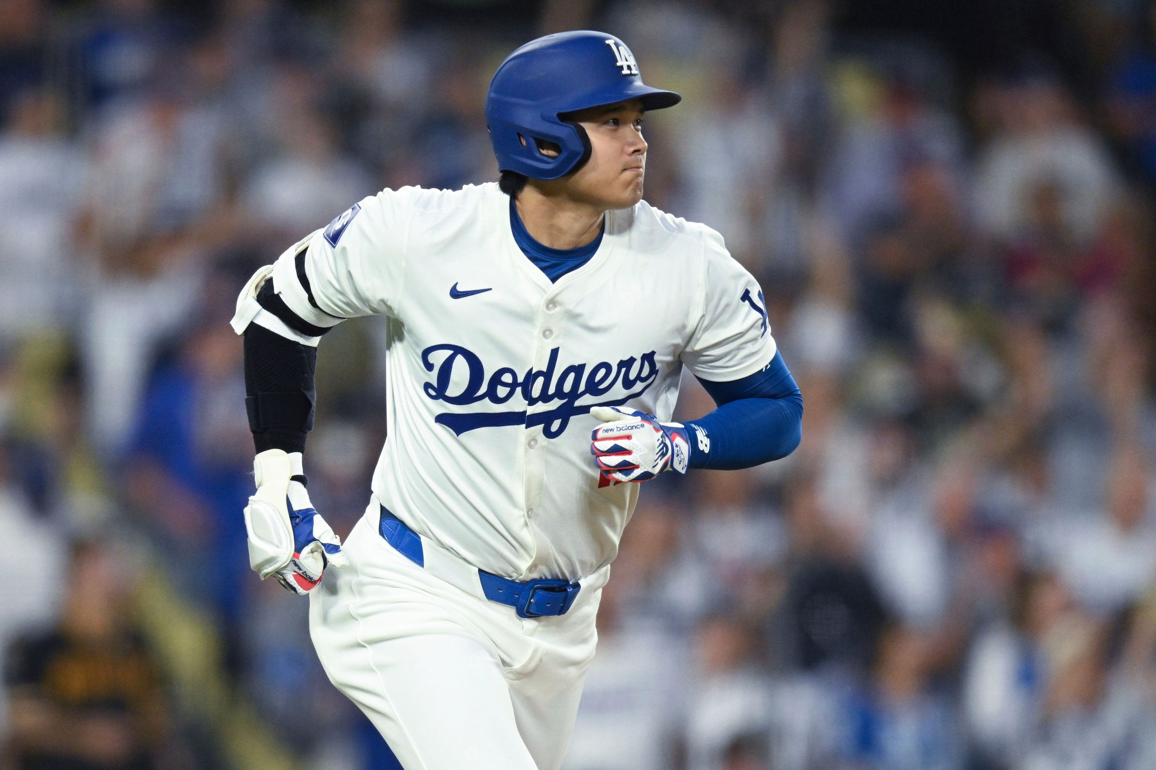 Los Angeles Dodgers' Shohei Ohtani (17) runs to first after hitting a home run against the Pittsburgh Pirates during the second inning of a baseball game at Dodger Stadium Friday, Aug. 9, 2024, in Los Angeles. (AP Photo/John McCoy)