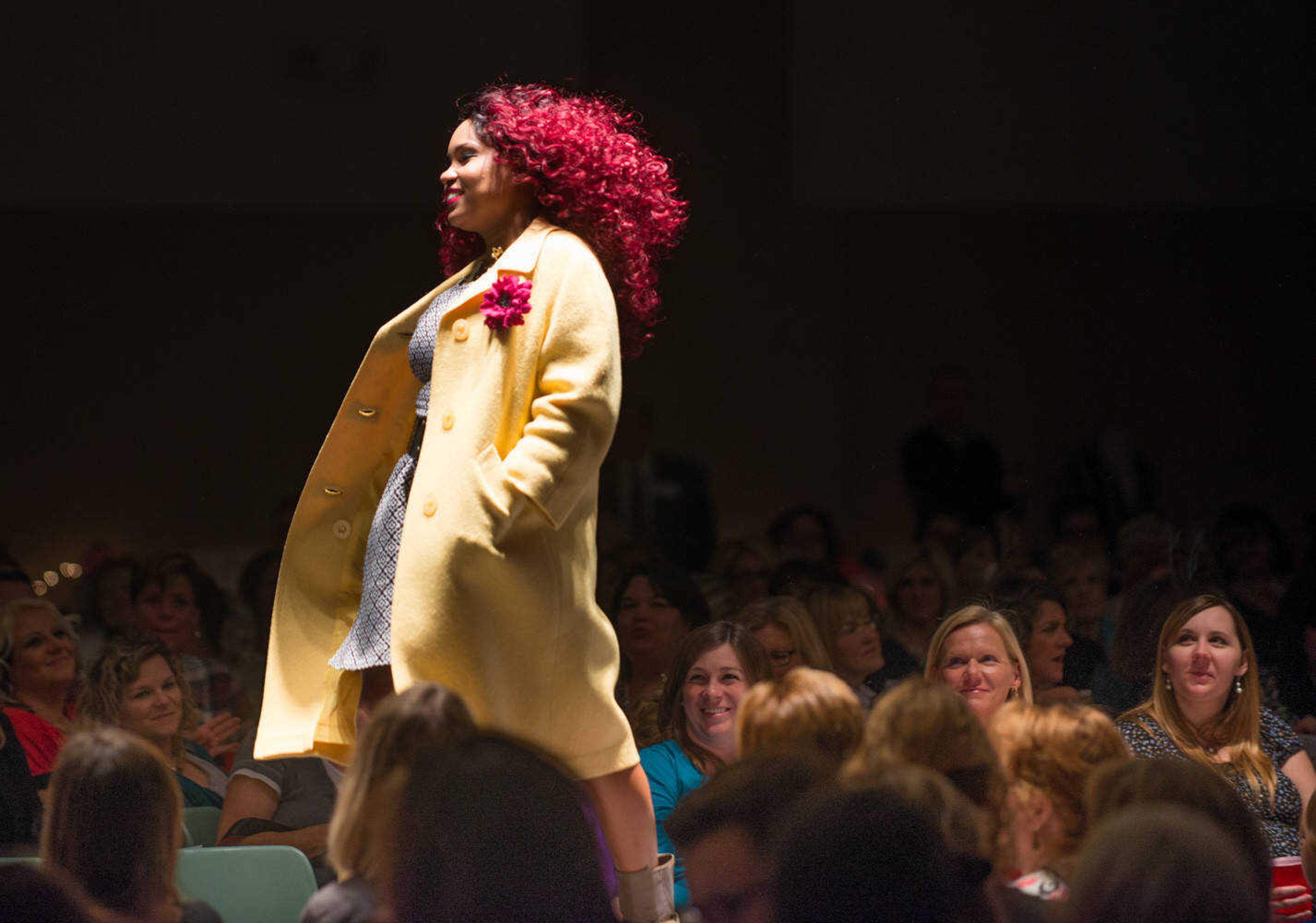 AARON EISENHAUER ~ photos@semissourian.com
Kaleisha Walker breezes past attendees during the fifth annual VintageNOW fashion show, a fundraiser for Safe House for Women, at the Osage Centre on Friday, October 17, 2014.