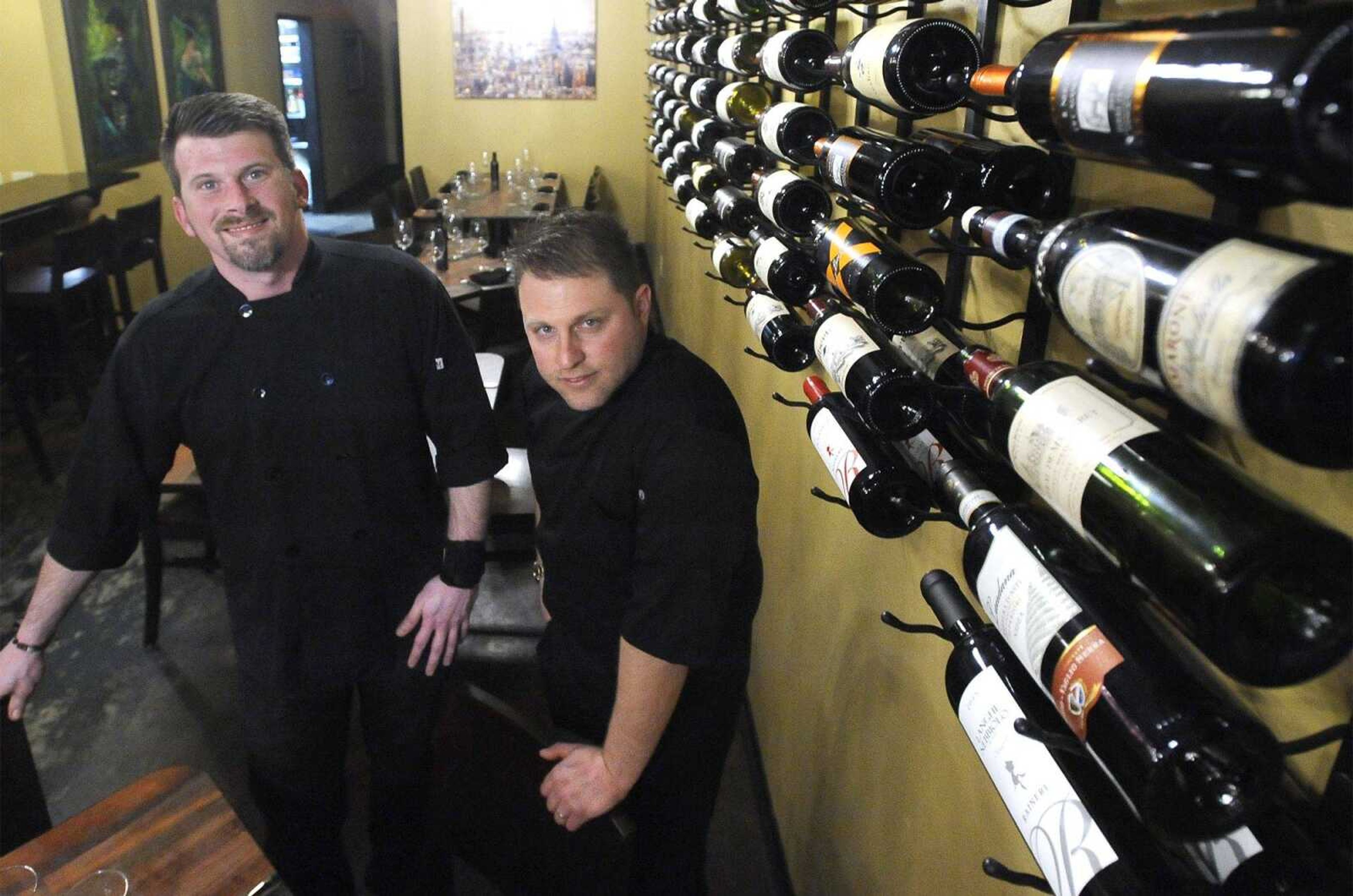 Jeremy Bourland, left, and Gabriele Ruggieri show the wine rack Friday at Gabriel's Food + Wine, 127 N. Main St. in Cape Girardeau.