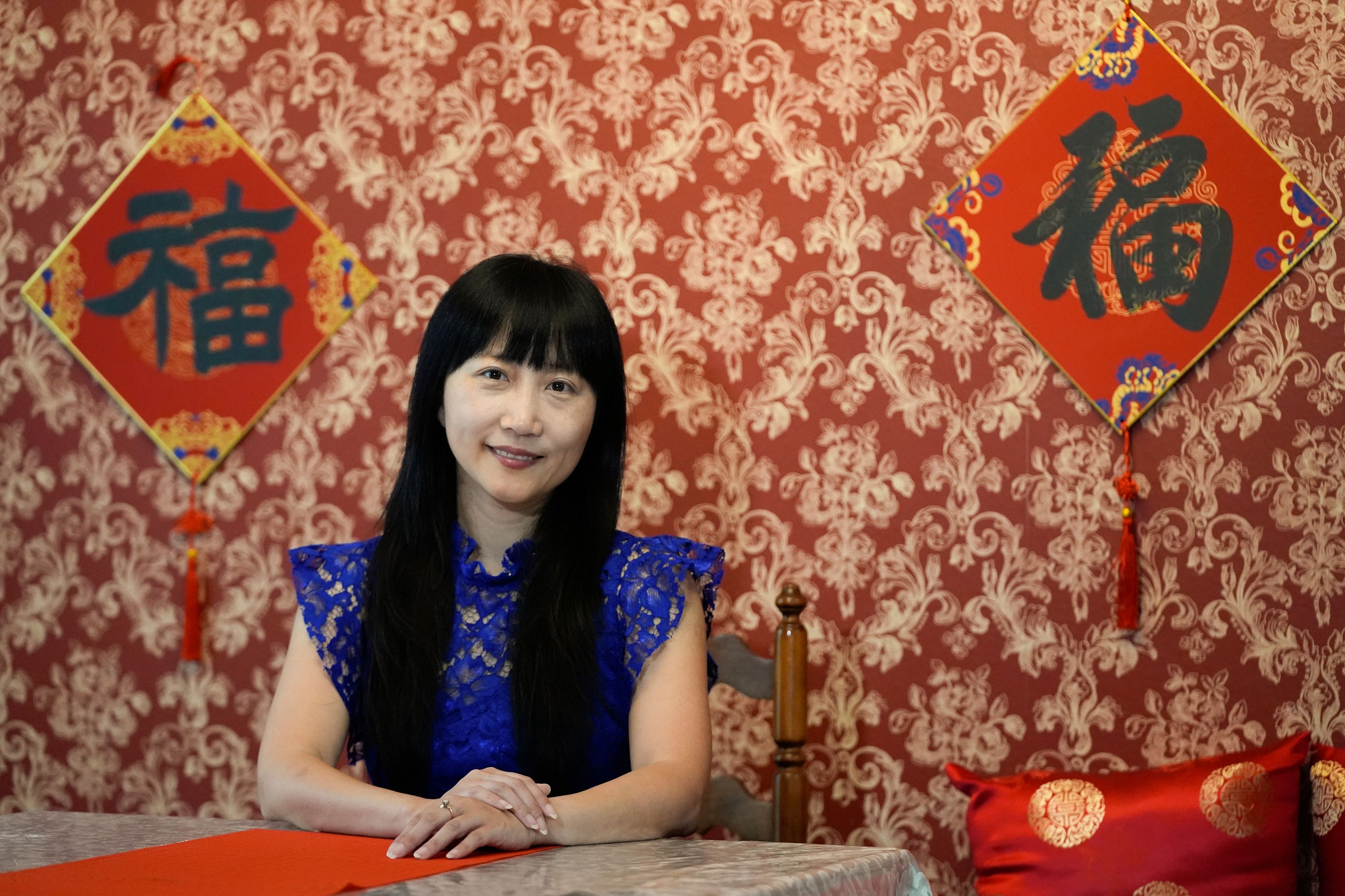 Diana Xue poses for a photo at her home Monday, Oct. 21, 2024, in Orlando, Fla. Xue is a naturalized U.S. citizen born in China who used to vote more Republican but has changed her mind after Florida passed the alien land law. (AP Photo/John Raoux)