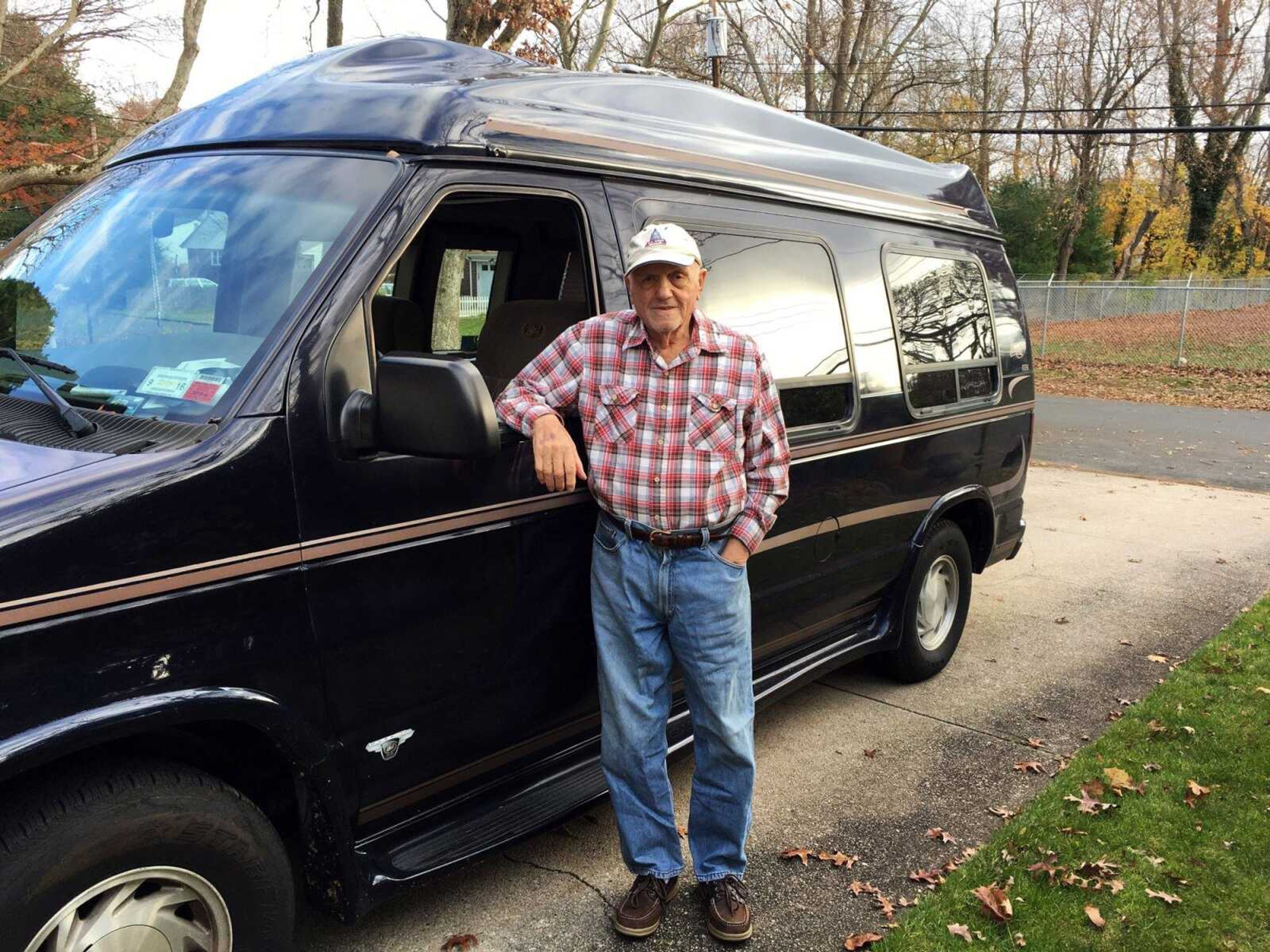 This photo provided by Jerome Minerva shows his father, Joe Minerva, 86, standing next to his Ford E150 conversion van, in Huntington, New York. Minerva has been driving since 1946. He's a skilled and disciplined driver and he's never been in an accident. (Jerome Minerva via AP)