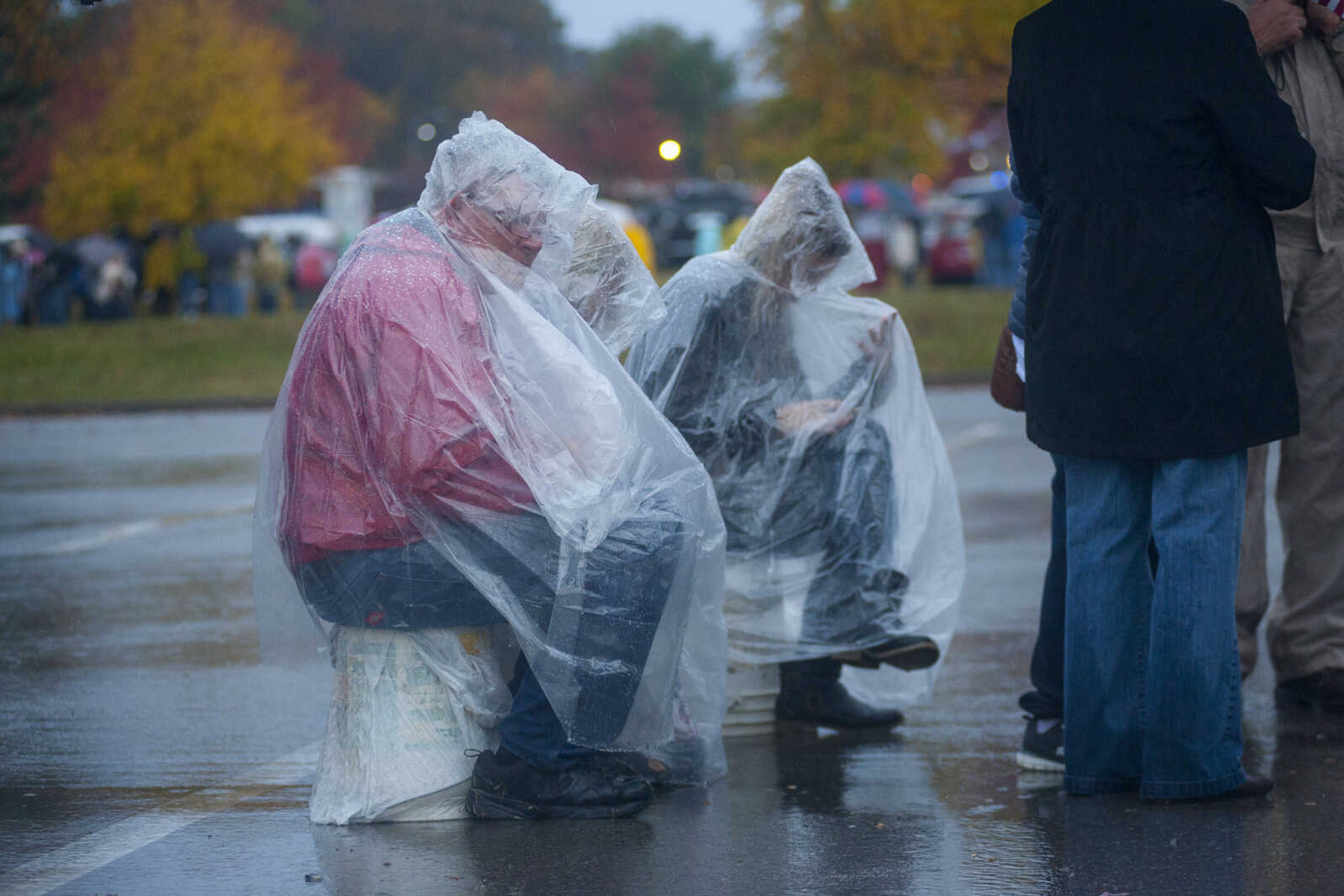 Rally-goers are seeing wearing ponchos outside of the Shoe Me Center Monday, Nov. 5, 2018, in Cape Girardeau.