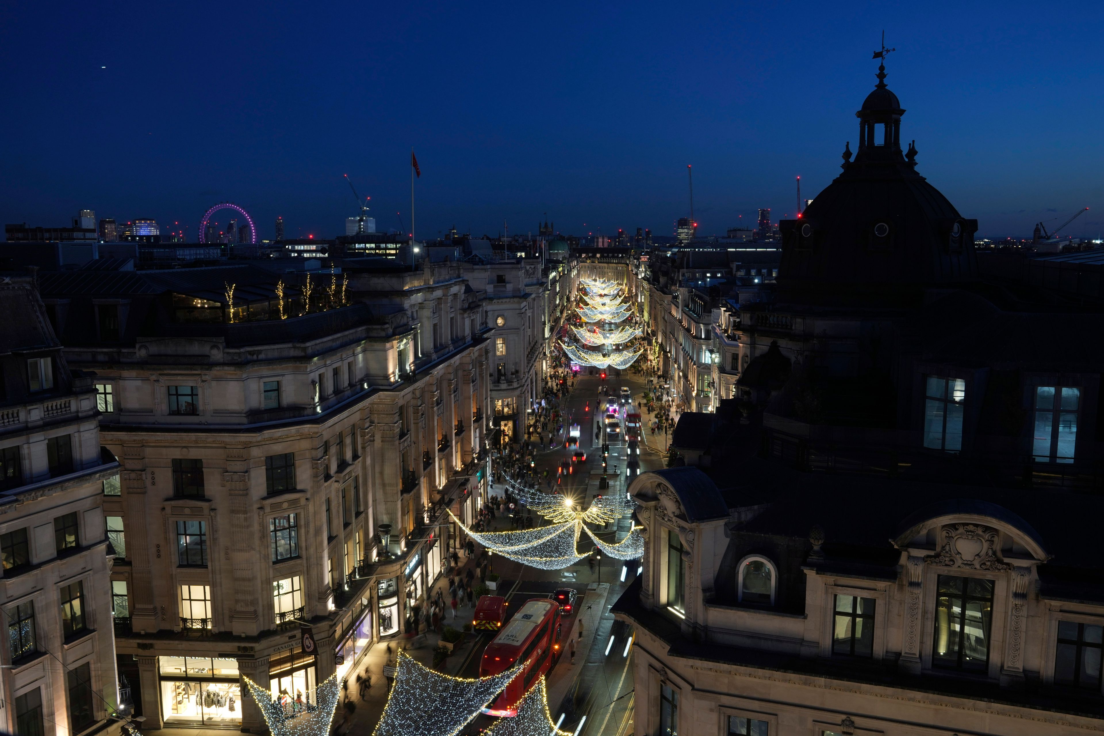 Christmas lights are displayed on Regent Street, in London, Wednesday, Nov. 20, 2024. (AP Photo/Kin Cheung)