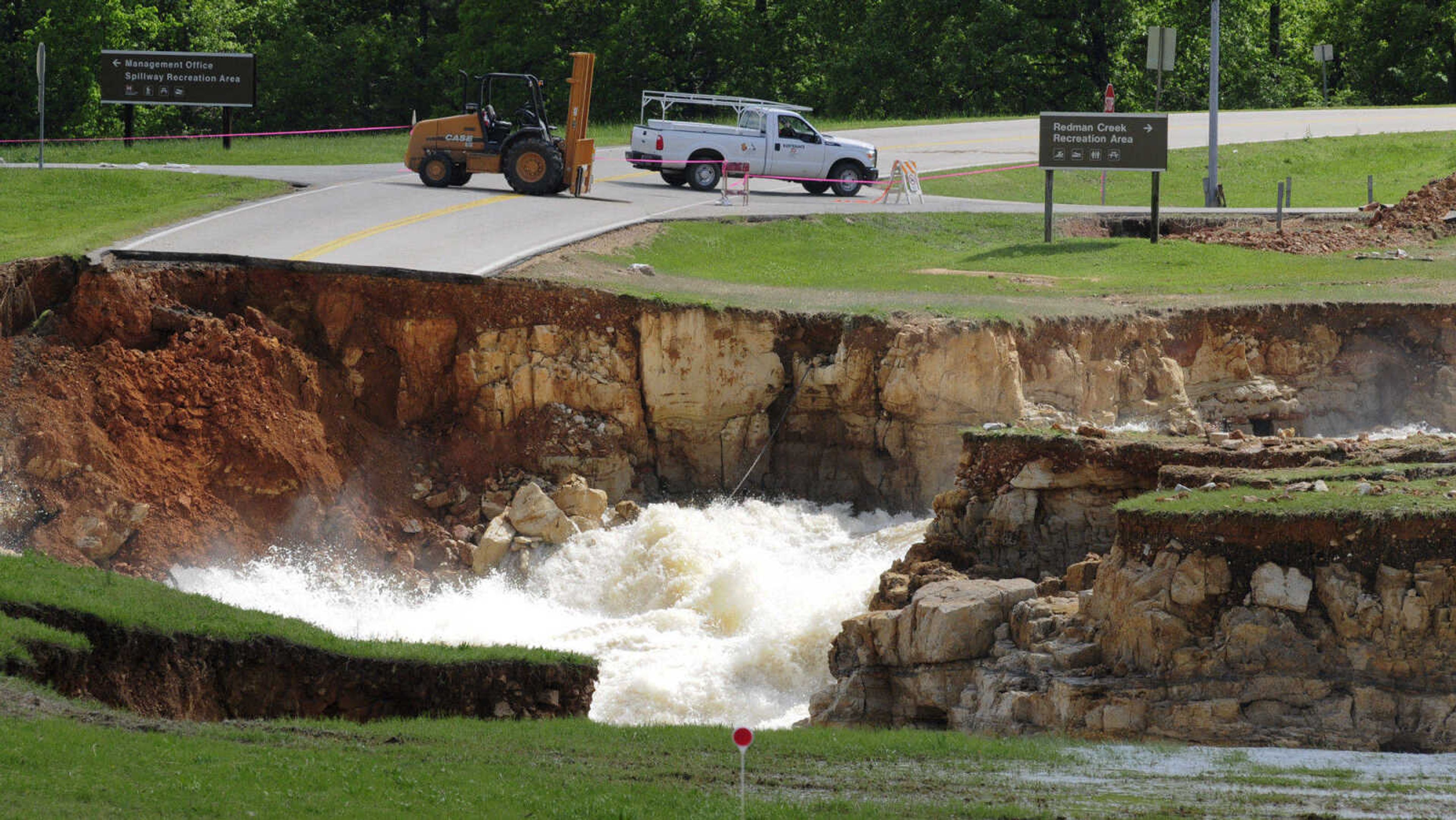 Highway T in Wayne County, Mo., is closed Tuesday, May 3, 2011 as raging floodwaters from Wappapello Lake, which overtopped an emergency spillway, pour through the area and into the St. Francis River. The waters took out a nearly 400-foot long section of the roadway. (AP Photo/Daily American Republic, Paul Davis)