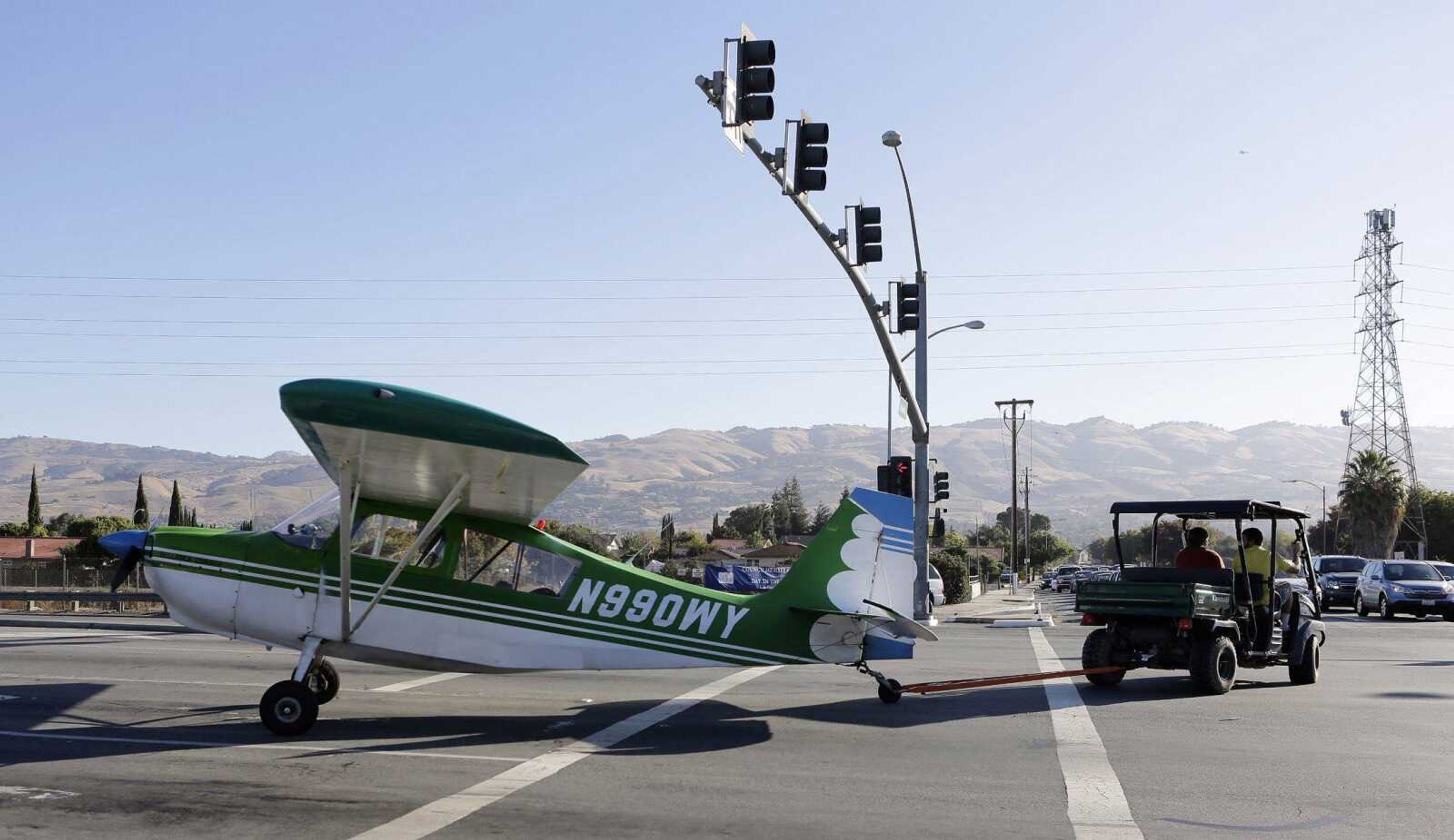 A small plane is towed away from Capitol Expressway and Quimby Road after making an emergency landing in San Jose, Calif., on Thursday. The plane landed near the Reid-Hillview Airport. No injuries were reported. (Gary Reyes ~ Bay Area News Group)