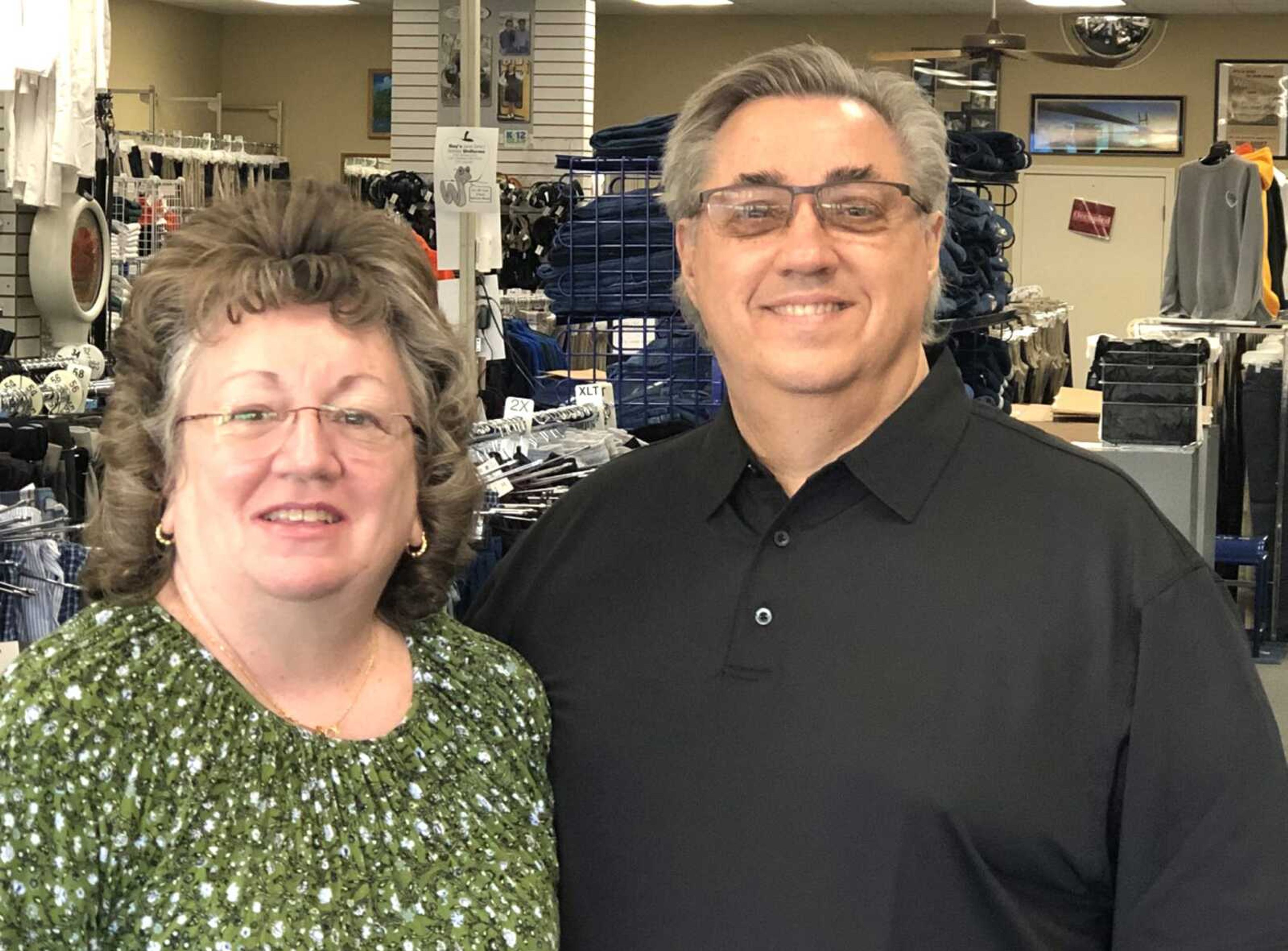 Curt and Penny Johns, owners of Guys Big&#9679;Tall and Guy's Uniforms in the Town Plaza Shopping Center, will retire soon after 41 years in business. They're shown here inside their store Thursday.