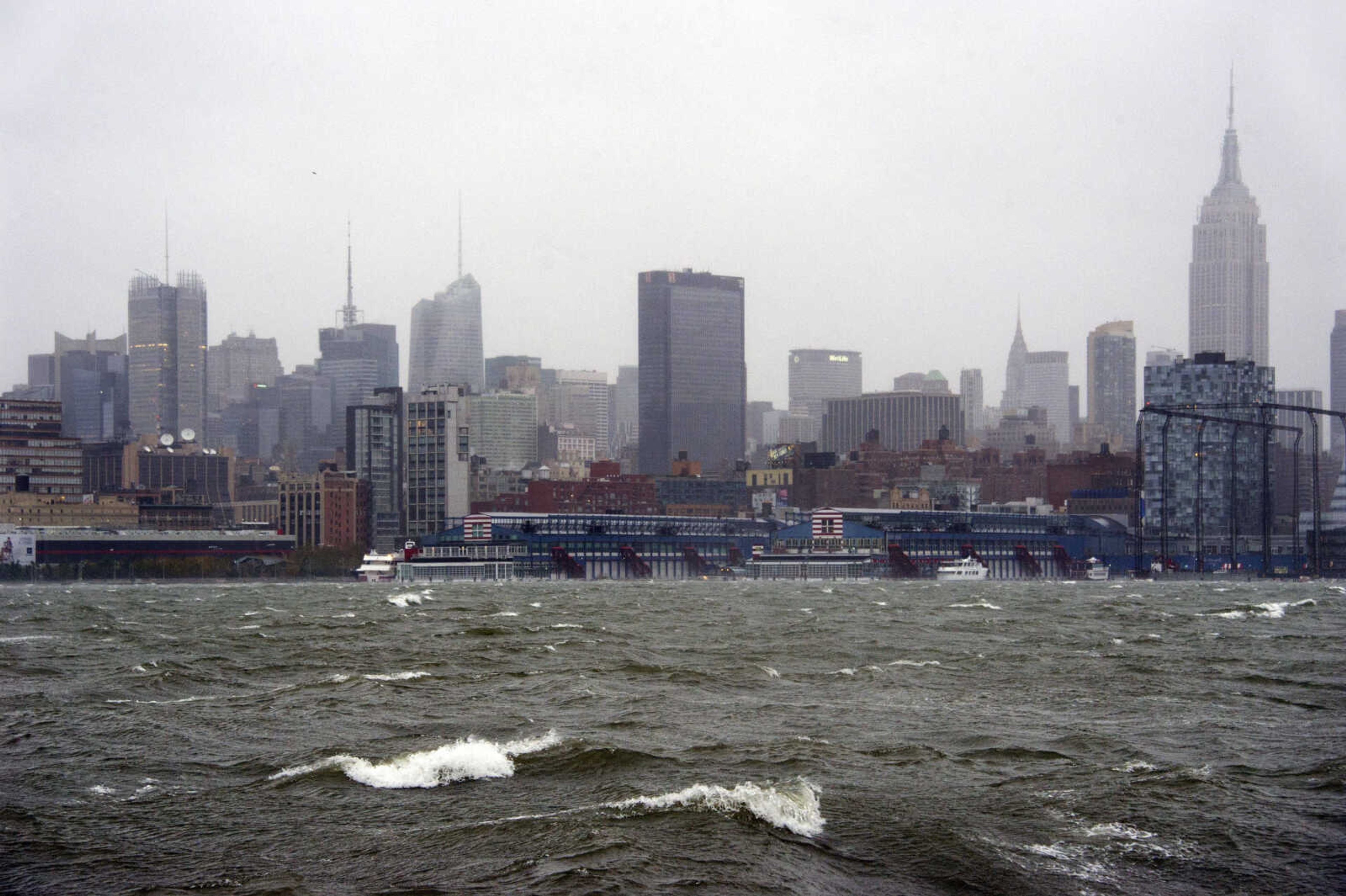 The New York City skyline and Hudson River are seen from Hoboken, NJ as Hurricane Sandy approaches on Monday, Oct. 29, 2012. Hurricane Sandy continued on its path Monday, as the storm forced the shutdown of mass transit, schools and financial markets, sending coastal residents fleeing, and threatening a dangerous mix of high winds and soaking rain.  (AP Photo/Charles Sykes)