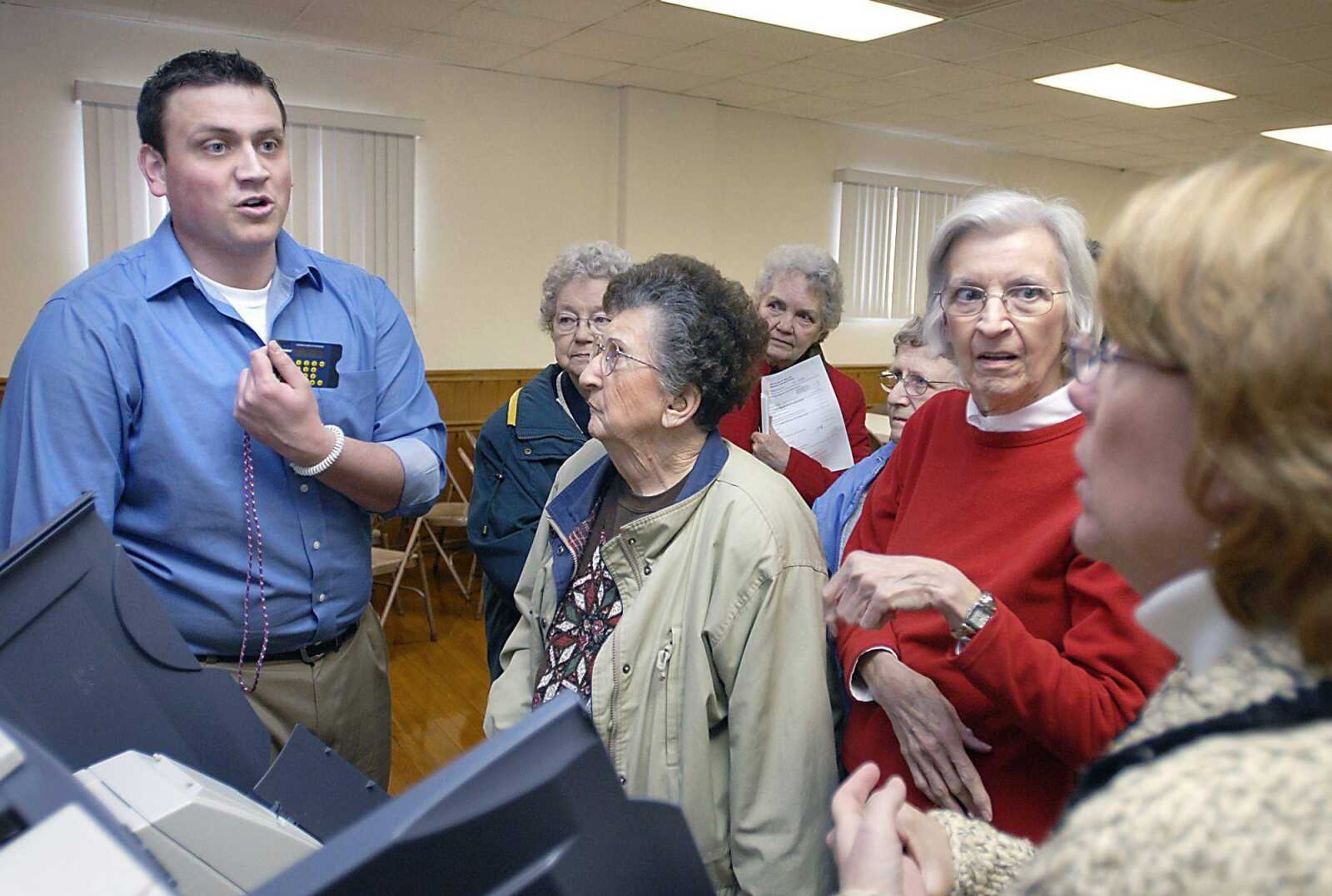 Election supervisor Joey Keys, left, explained how to use a voting machine for special circumstances Tuesday at the American Legion Hall in Jackson. Betty Wilson, June Pender and Marlene Lindman asked Keys questions following the poll worker training session. in preparation for Super Tuesday. (Kit Doyle)