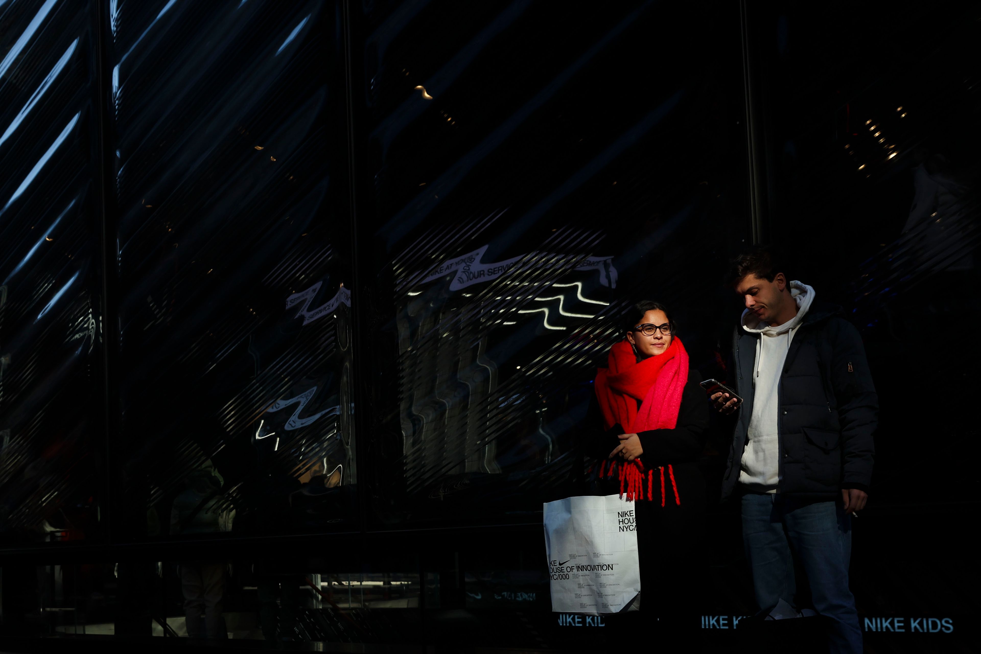 Shoppers wait outside to enter the Nike store on Fifth Avenue, Friday, Nov. 29, 2024, in New York. (AP Photo/Heather Khalifa)