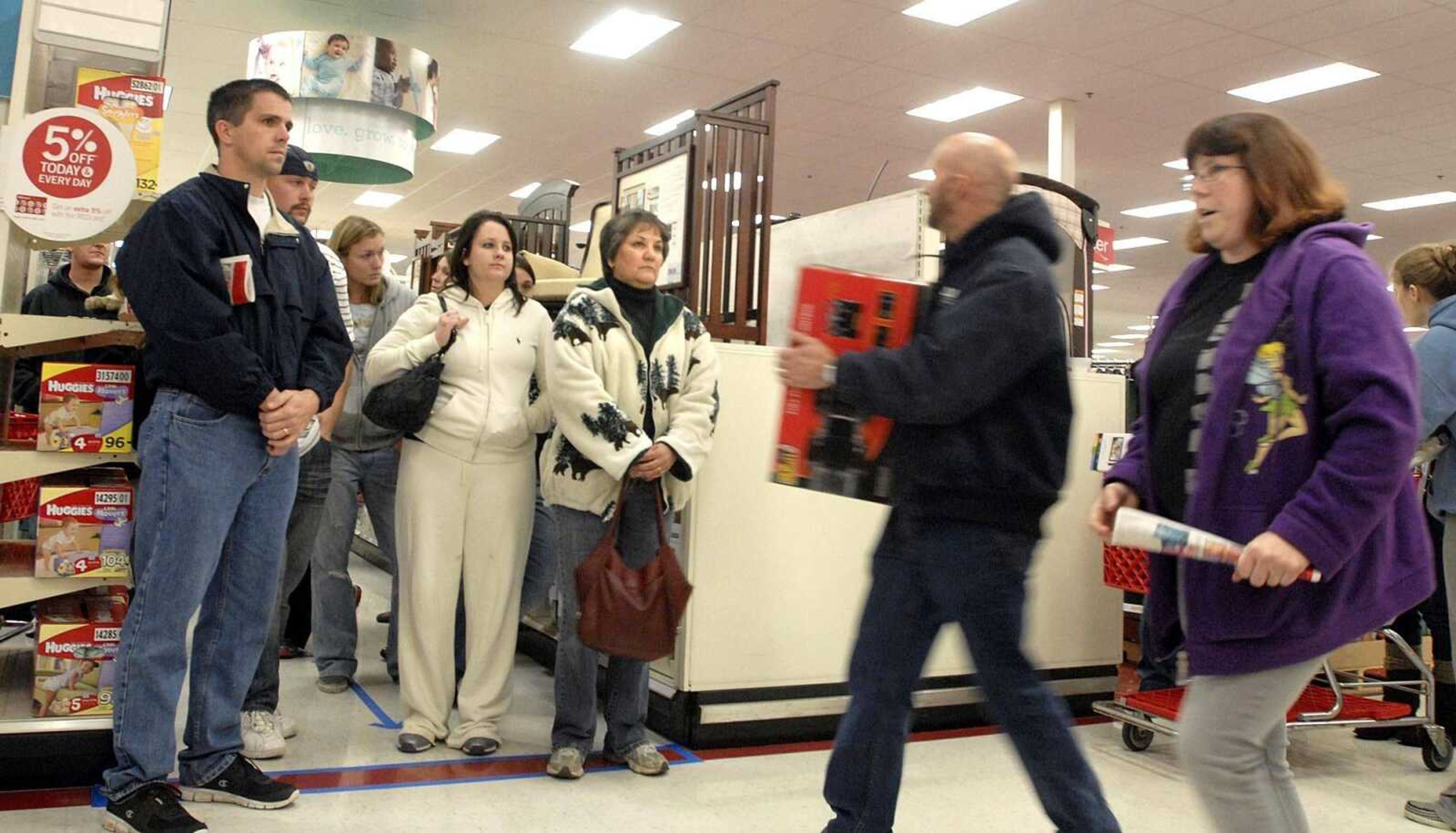 LAURA SIMON ~ lsimon@semissourian.com
Shoppers scurry past those waiting in the electronic sales line that winds through the baby section of Target Friday, November 25, 2011 in Cape Girardeau.