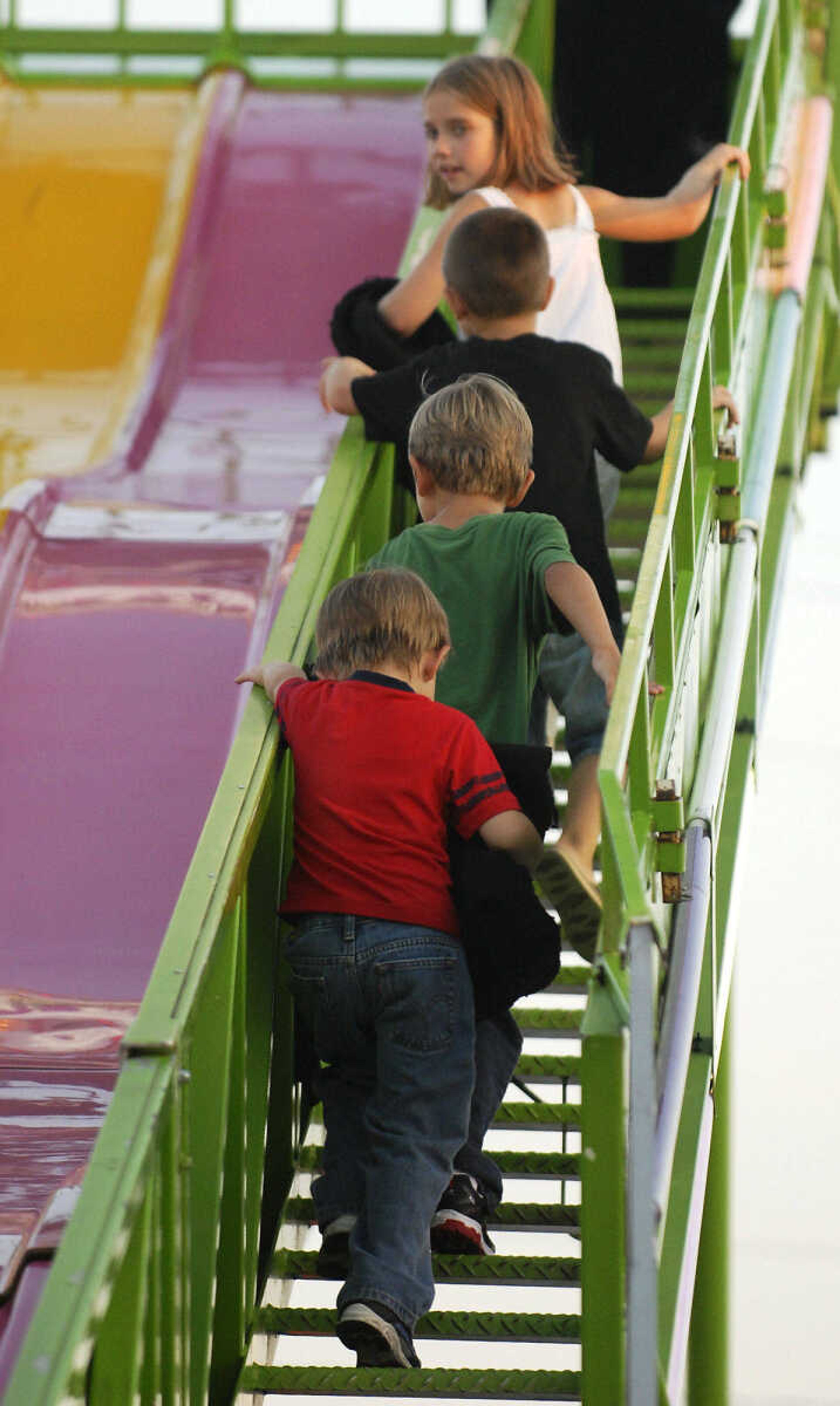 KRISTIN EBERTS ~ keberts@semissourian.com

From top, Jada Martin, 8, cousin Ty Martin, 4, Isaac LeGrand, 6, and cousin Jaiden Glency, 4, climb to the top of the slide during the 102nd Annual Homecomers Celebration in Jackson on Saturday, July 31, 2010. Saturday was the final day of the celebration, which began on Tuesday.