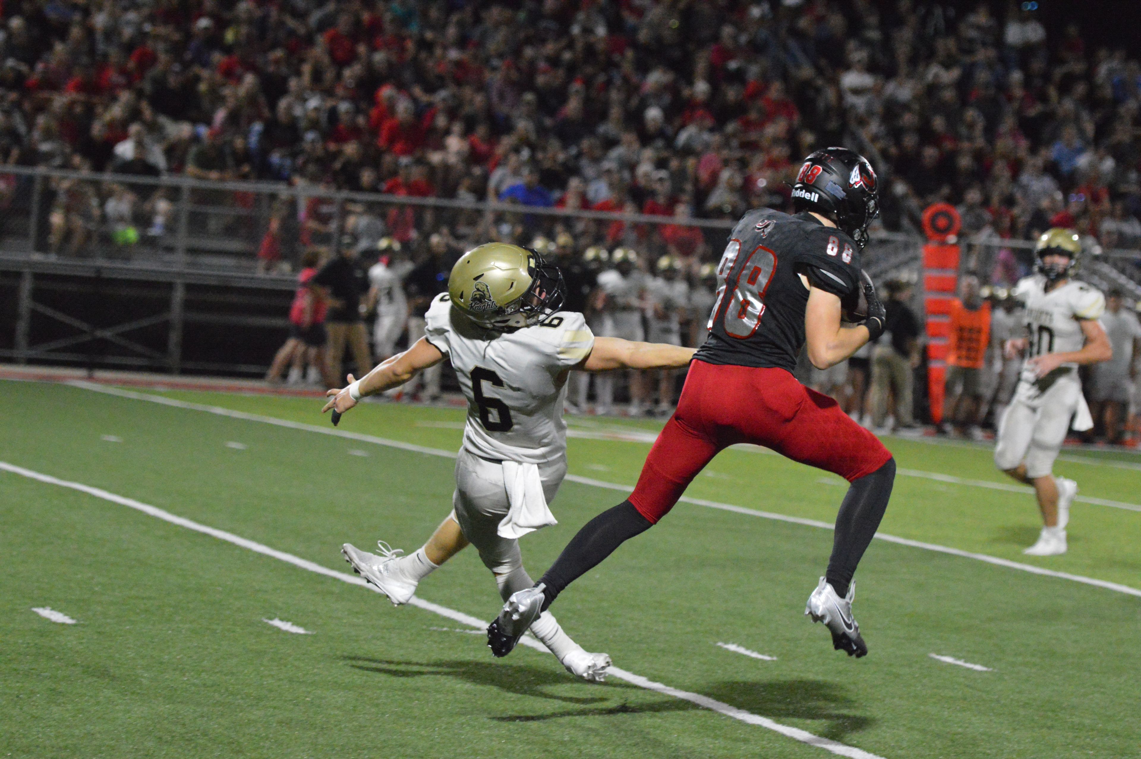 Jackson sophomore wide receiver Jory Thoma catches a deep ball in one-on-one coverage against Farmington on Friday, Sept. 20.