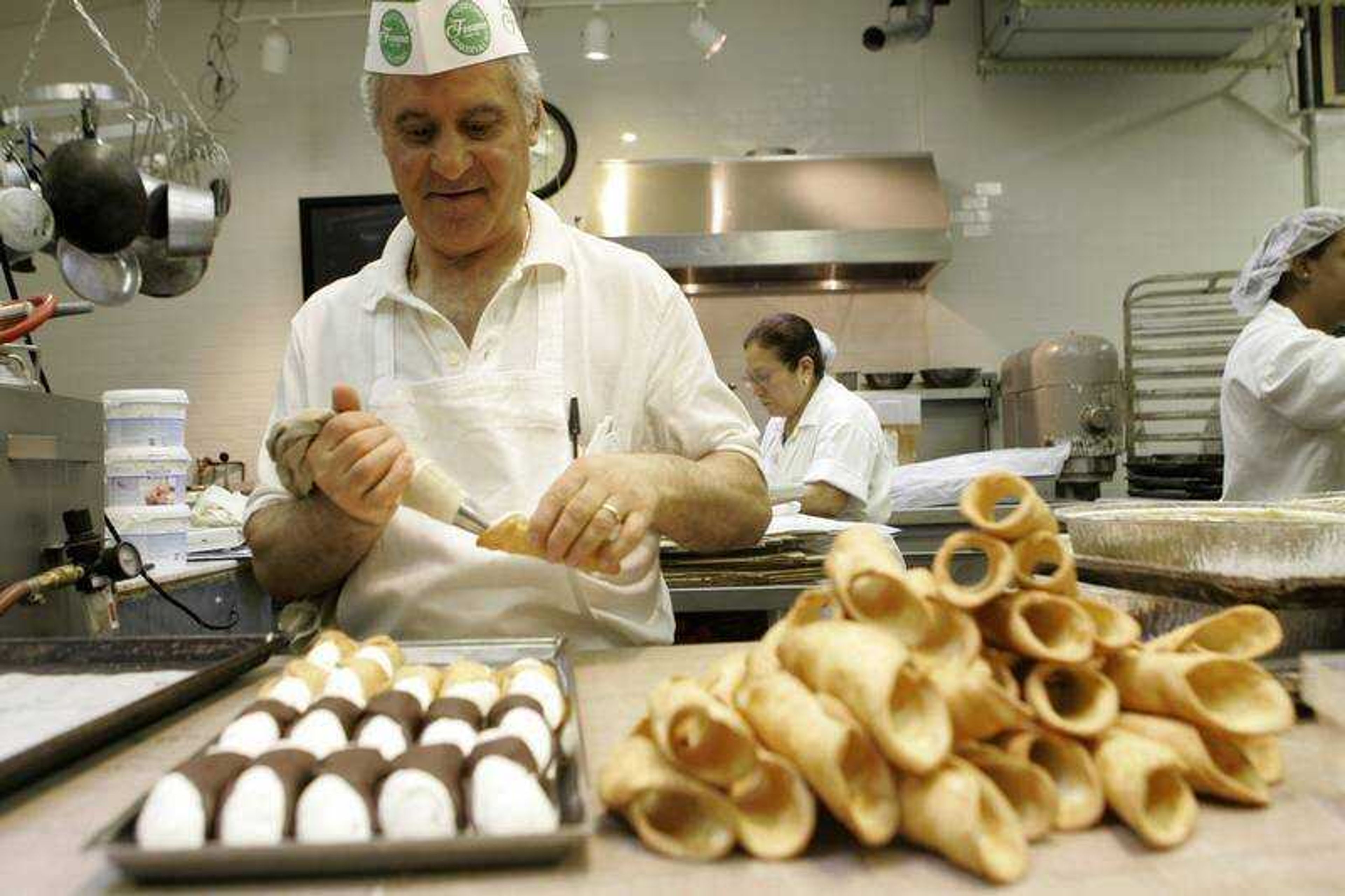 Chef Fanco Amati stuffs cannoli shells at the Ferrara Bakery in New York's Little Italy Friday, June 27, 2008 in New York. New York's trans fat ban, the first to be adopted by an American city, is expanding next month to include almost all prepared food sold to the public _ in restaurants, bakeries, cafeterias, salad bars, food carts. It initially covered only cooking oils for things like french fries and fried chicken. (AP Photo/Mary Altaffer)