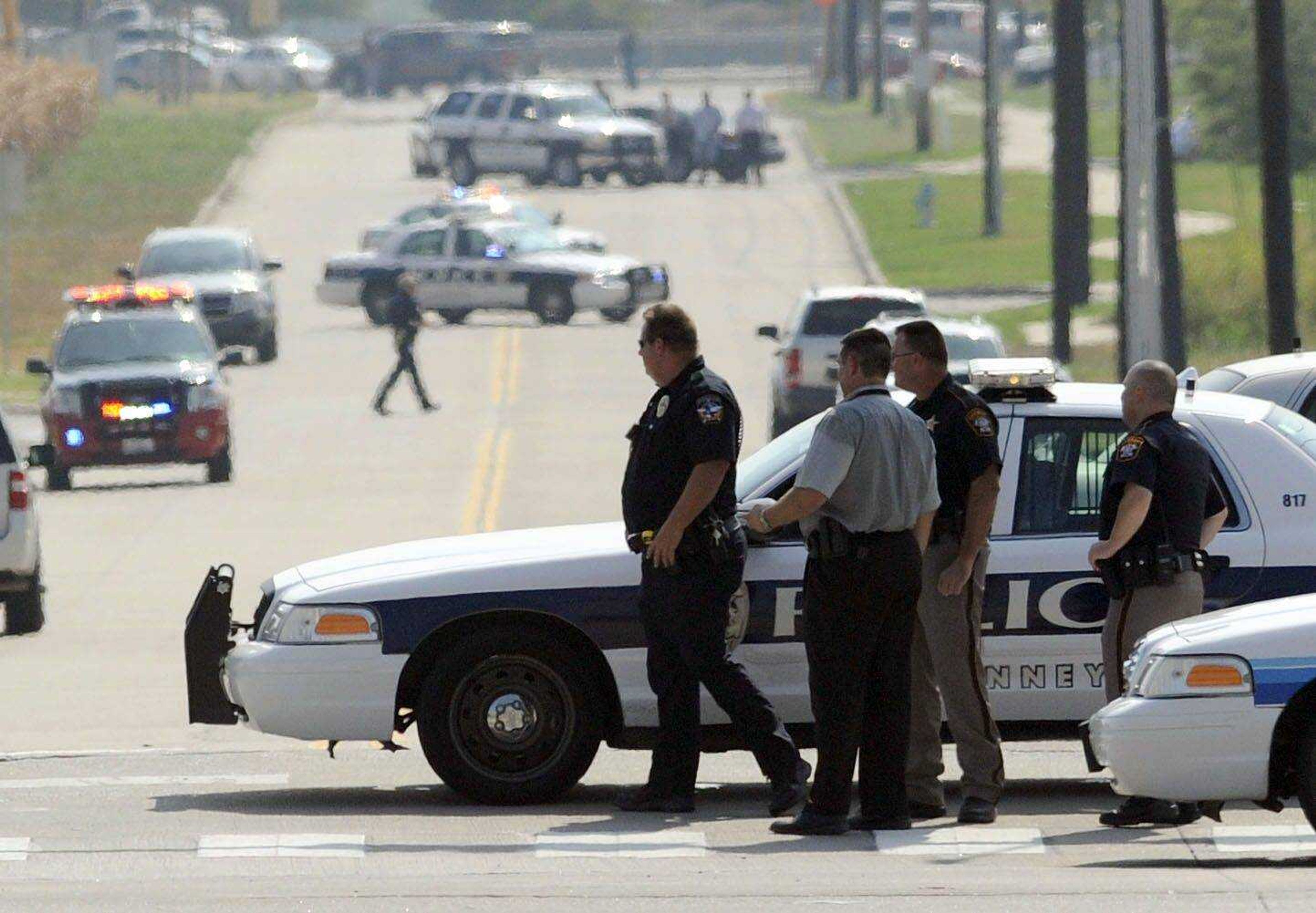 Police investigate a shooting in north McKinney on Tuesday Aug. 17, 2010 in McKinney, Texas. A man drove a pickup truck loaded with ammunition into a suburban Dallas police station's parking lot Tuesday, set the truck on fire and exchanged gunfire with police, officials said. The gunman was the only casualty and died at the scene. (AP Photo/The Dallas Morning News, Matt Strasen) ** MANDATORY CREDIT, MAGS OUT, TV OUT, INTERNET OUT, AP MEMBERS ONLY **