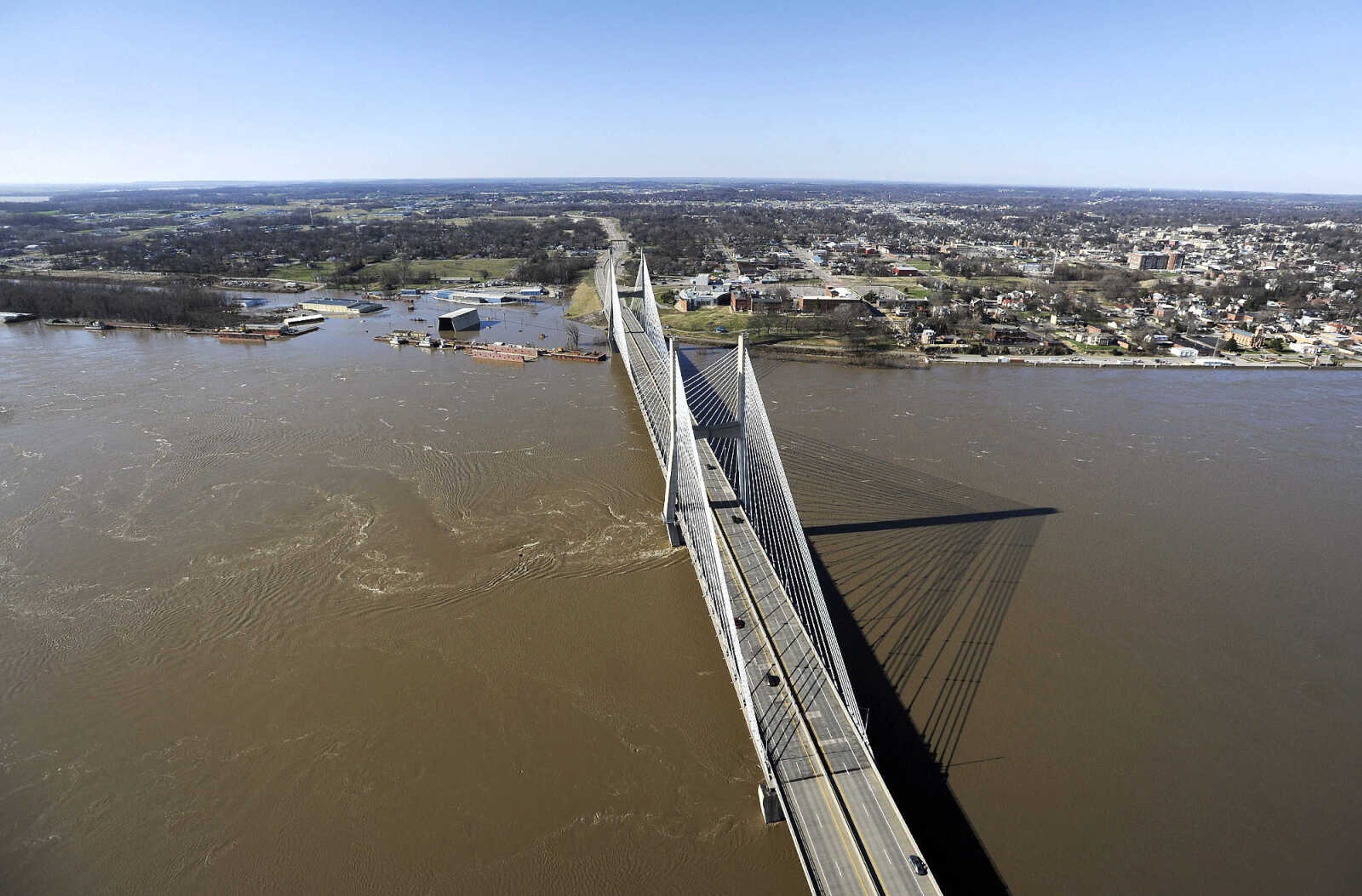 LAURA SIMON ~ lsimon@semissourian.com

The swollen Mississippi River is seen flowing under the Bill Emerson Memorial Bridge in Cape Girardeau, Saturday, Jan. 2, 2016.