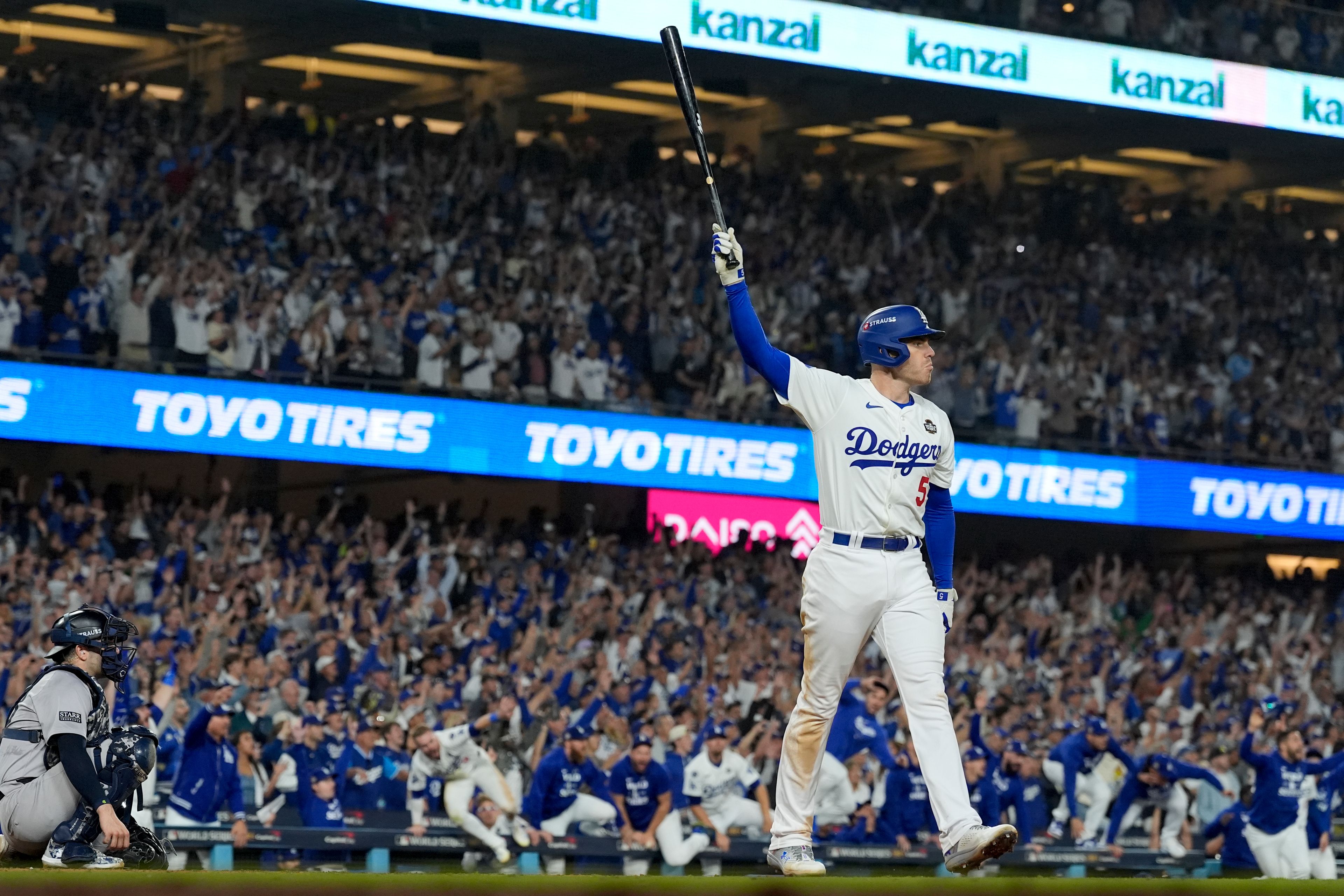 Los Angeles Dodgers' Freddie Freeman celebrates his walk-off grand slam home run against the New York Yankees during the 10th inning in Game 1 of the baseball World Series, Friday, Oct. 25, 2024, in Los Angeles. (AP Photo/Ashley Landis)