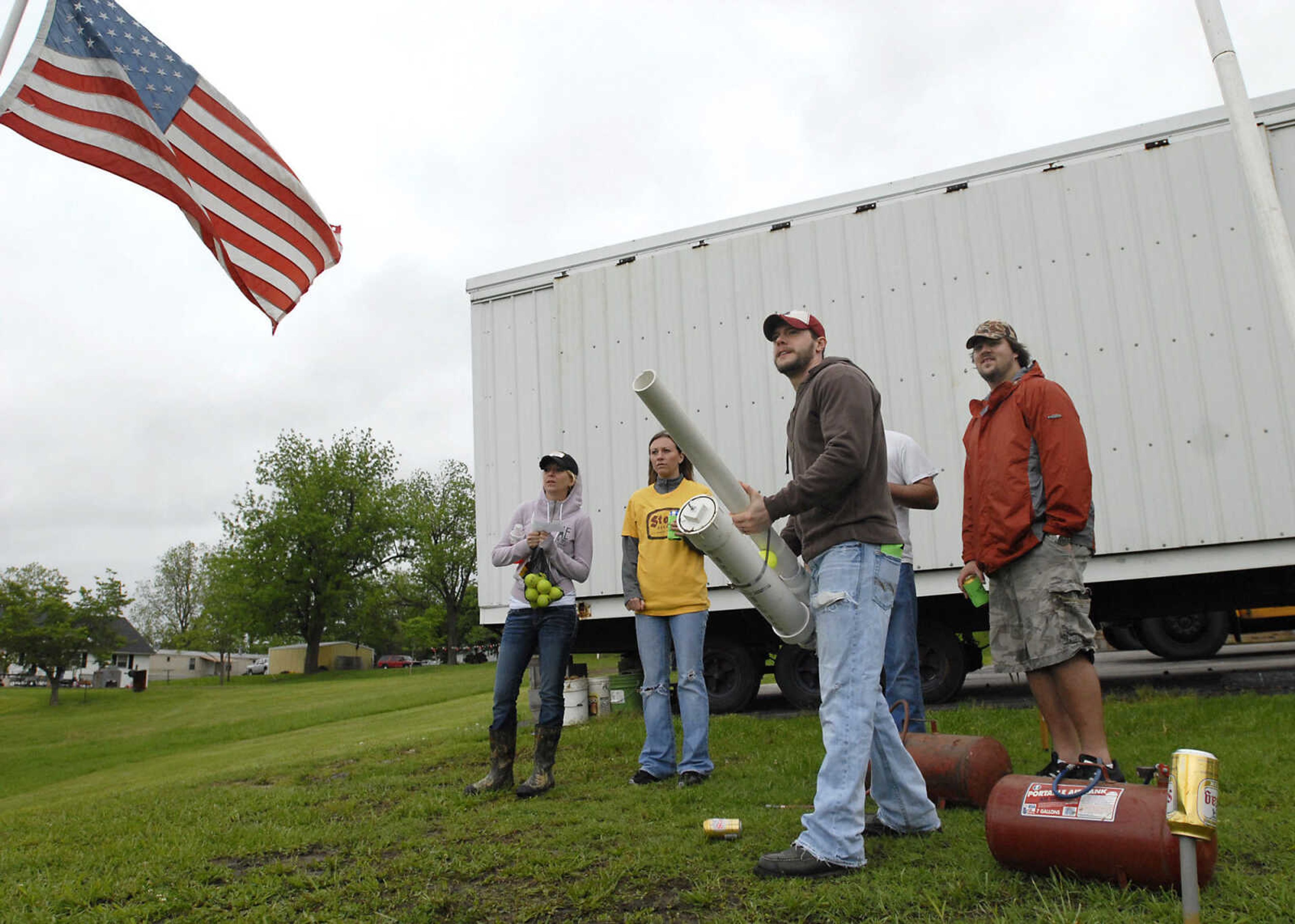 KRISTIN EBERTS ~ keberts@semissourian.com

Brandon Job steadies his potato gun for tee-off as teammates Lacey Job, Jessica Hartzold and Zach Arnold, from left, watch during the Kow Pasture Klassic at Schlinder's Tavern in New Hamburg, Mo., on Saturday, May 14, 2011. Proceeds from the event benefit the Kenny Rogers Children's Center and the Missouri Veterans Home.