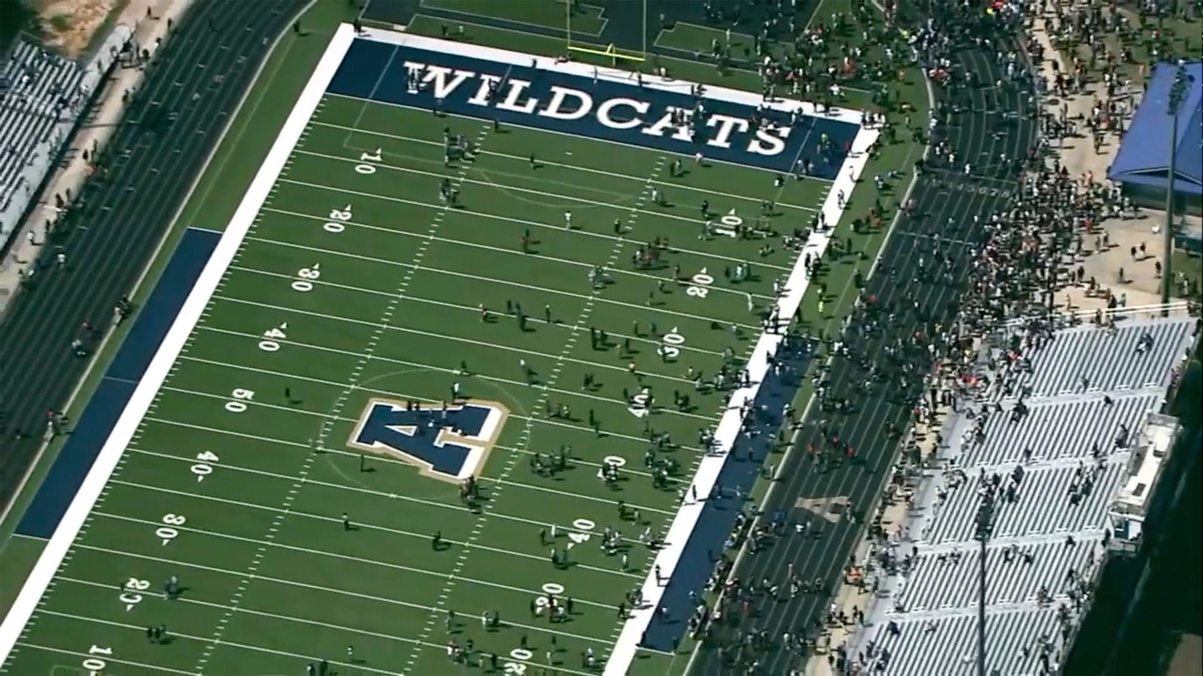 Students are evacuated to the football stadium after the school campus was placed on lockdown at Apalachee High School in Winder, Ga., on Wednesday, Sept. 4, 2024. (WSB via AP)