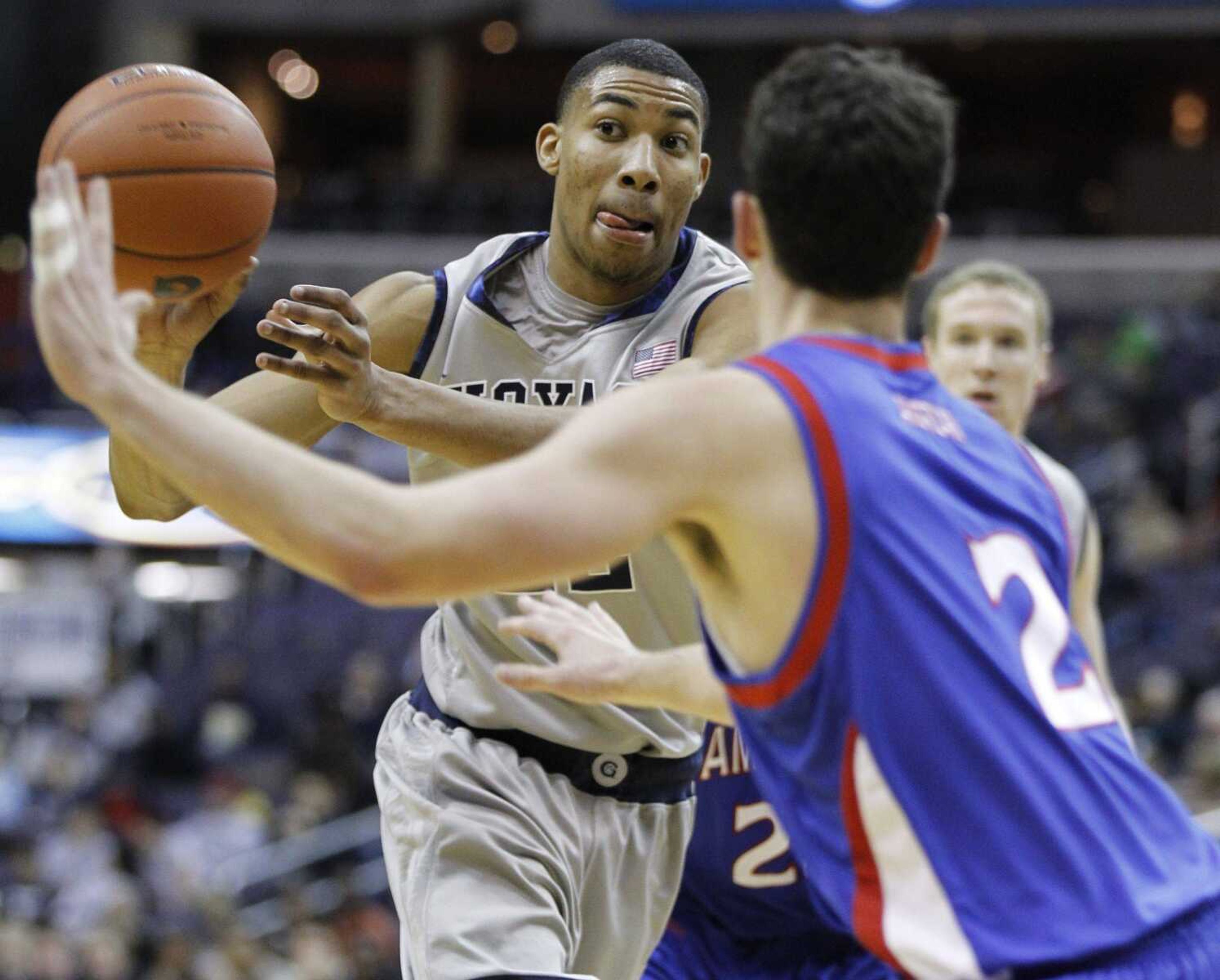 Georgetown's Otto Porter passes the ball as American's Daniel Munoz defends during the first half of their game earlier this season in Washington. (LUIS ALVAREZ ~ Associated Press)