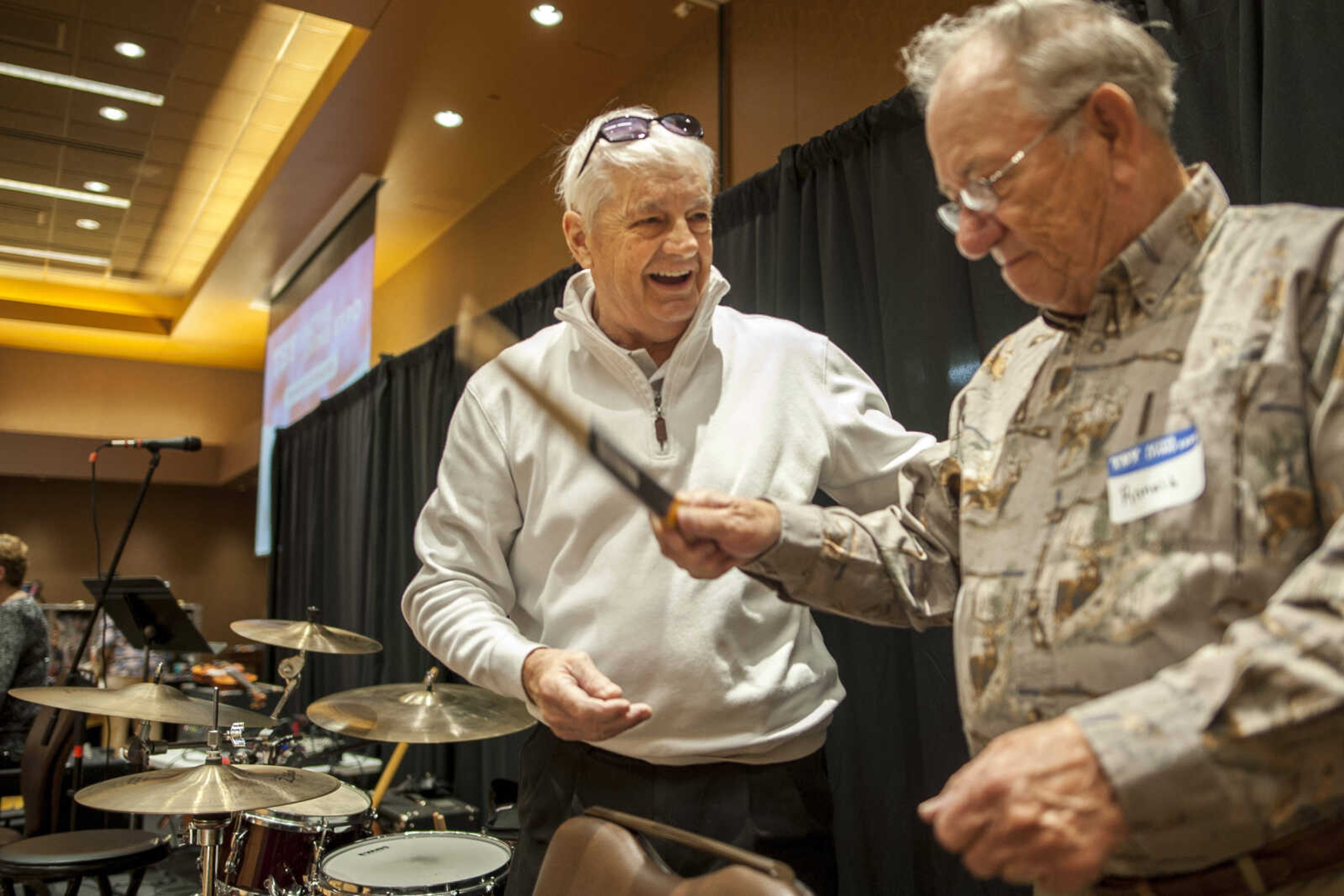 Steve Williams, left, smiles while getting drumming advice from his former schoolmate Ron Ethridge, right, during the TBY Active Living Expo Wednesday, Oct. 9, 2019, at the Isle Casino in Cape Girardeau.