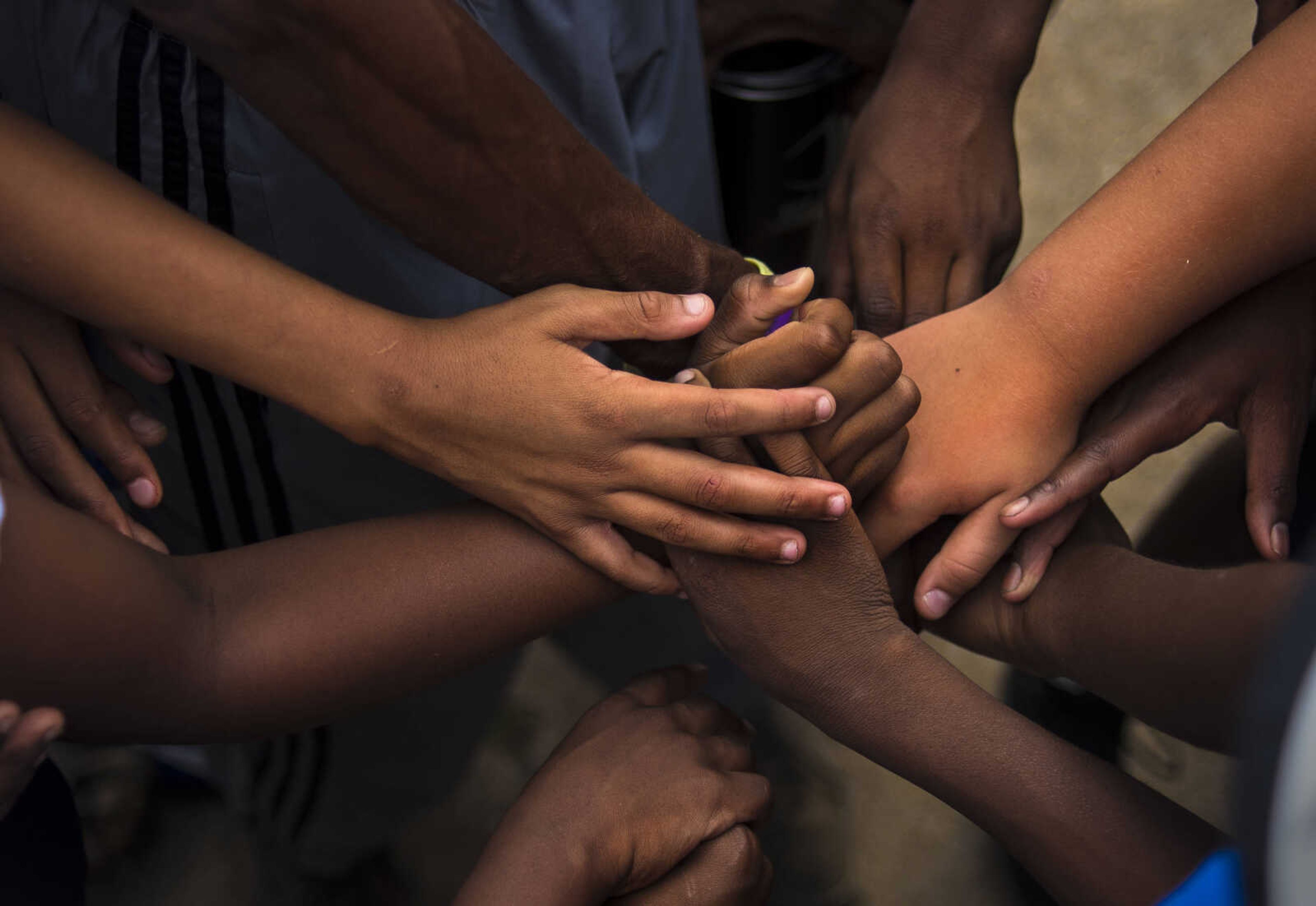 Mean Machine players put their hands together during practice Tuesday, August 29 2017 in Cape Girardeau. Coach Foster said once you're on the Mean Machine you are on the team for life. Every year players come and go but will never leave the family.