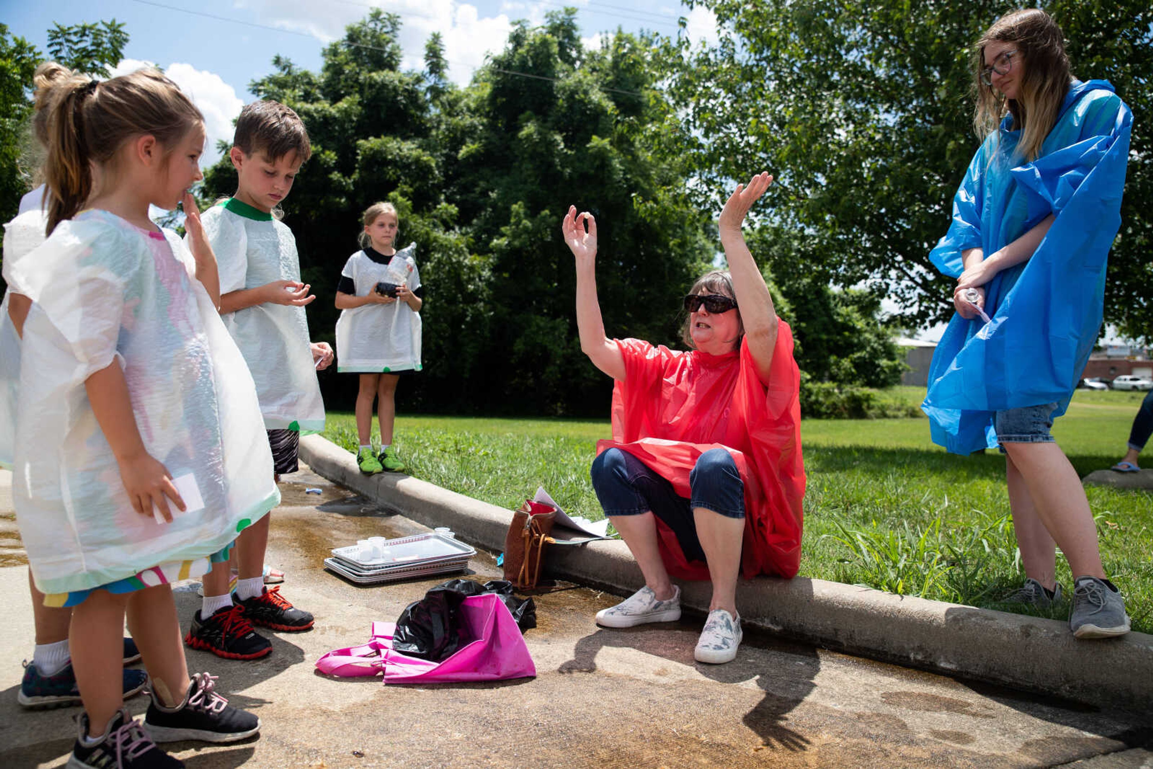 Becky Hicks, center, teaches kids about science during a program on Saturday, July 22, at the Cape Girardeau Public Library.