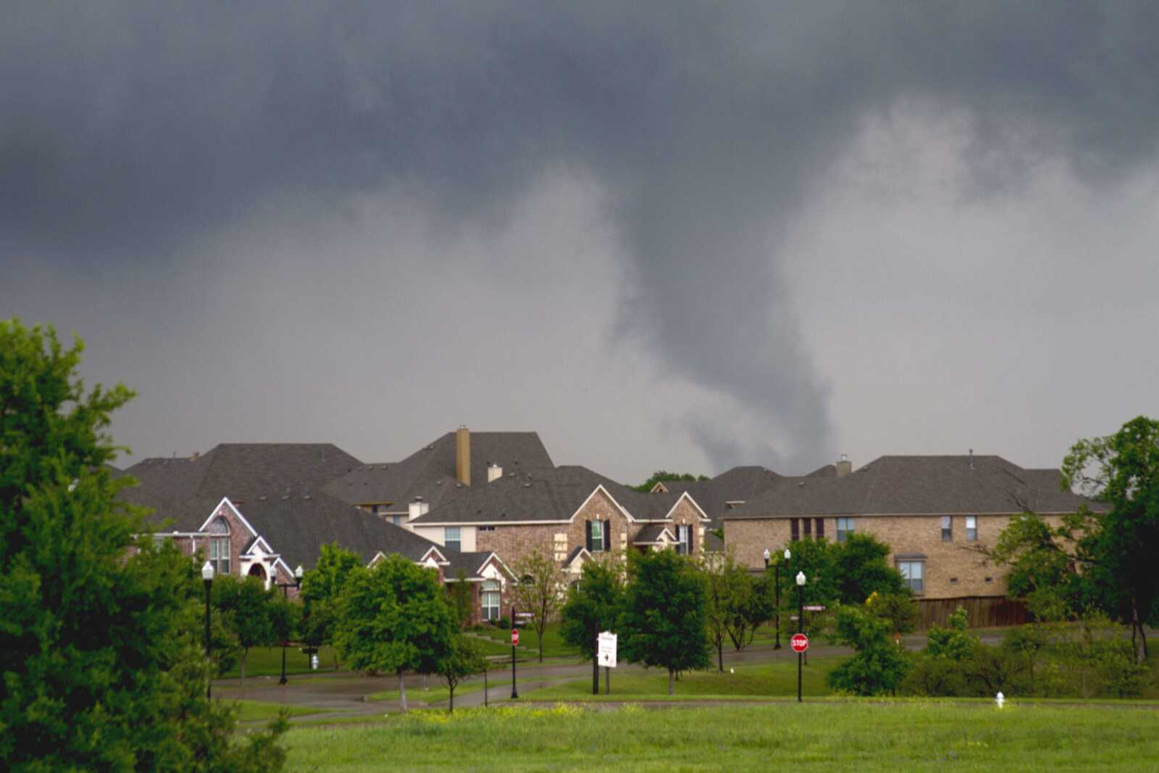 A funnel cloud begins to form Tuesday in southern Dallas County before a tornado touched down in Lancaster, Texas. (Parrish Velasco ~ The Dallas Morning News)