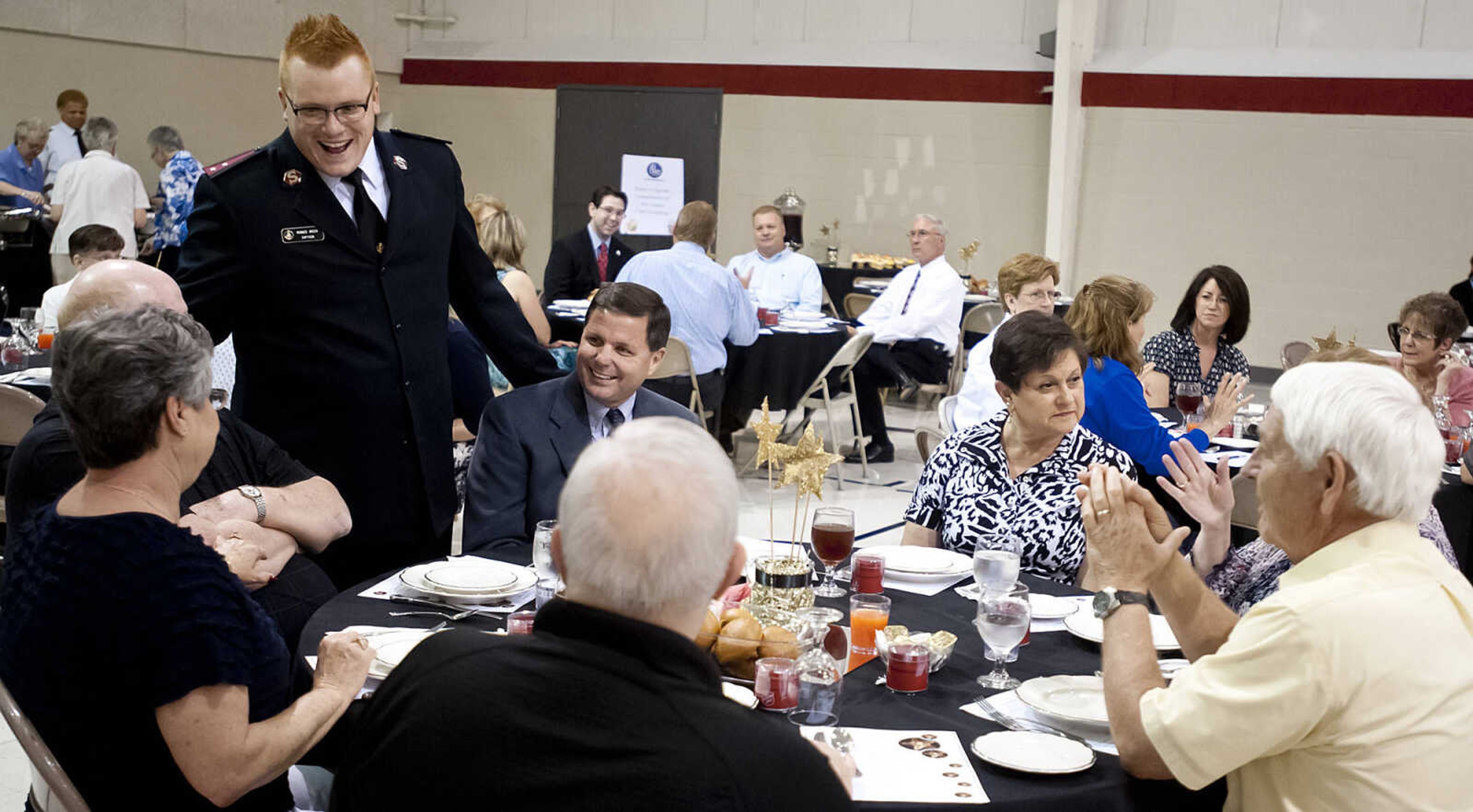 Capt. Ronnie Amick speaks to a table during the Cape Girardeau Salvation Army's annual dinner, "A Night with the Stars," Thursday, May 8, at the Cape Girardeau Salvation Army.