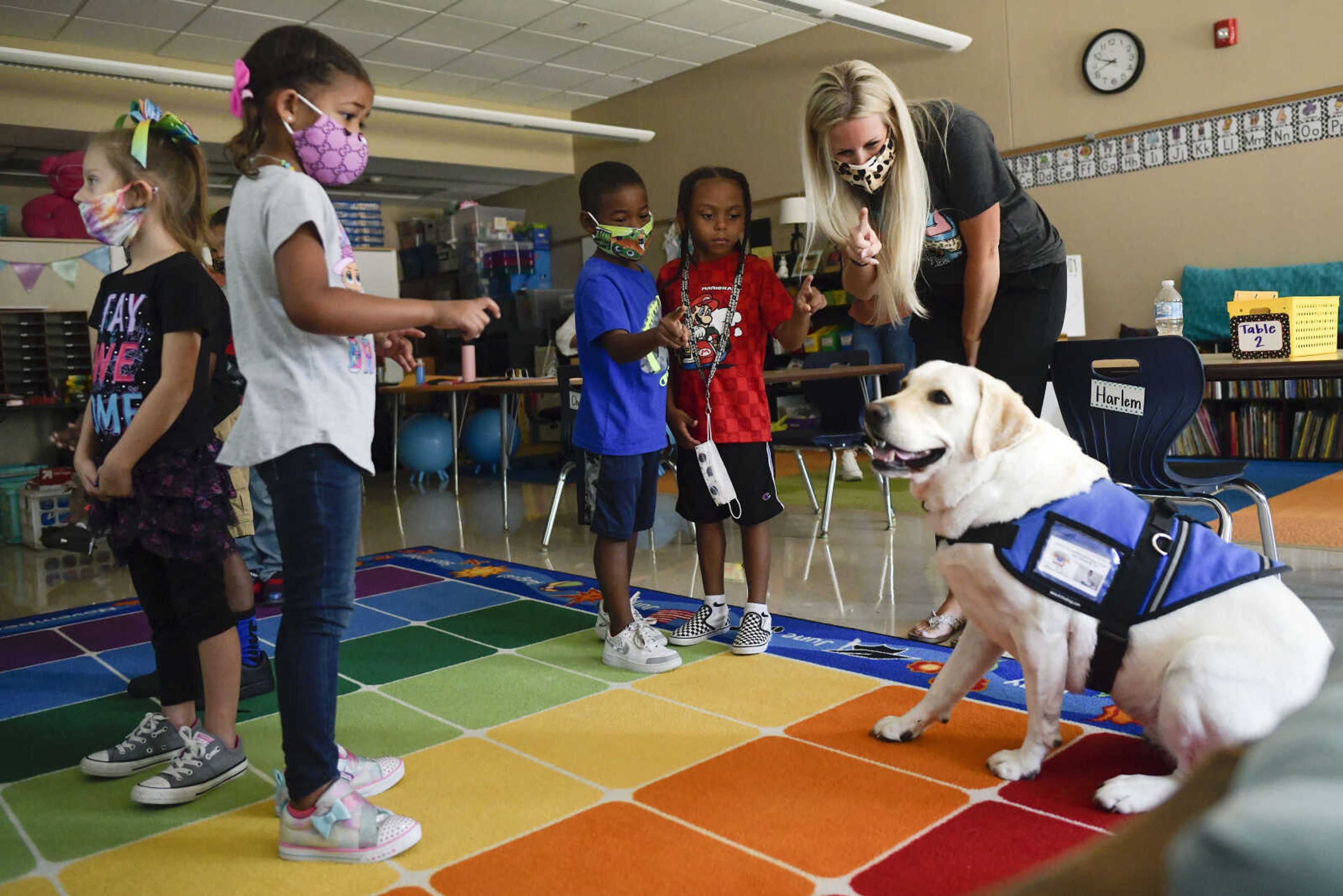 Franklin Elementary School kindergarten teacher Jamie Blattel shows her students how to "finger wave" at the school's therapy dog Teli on Monday, Aug. 24, 2020, in Cape Girardeau.