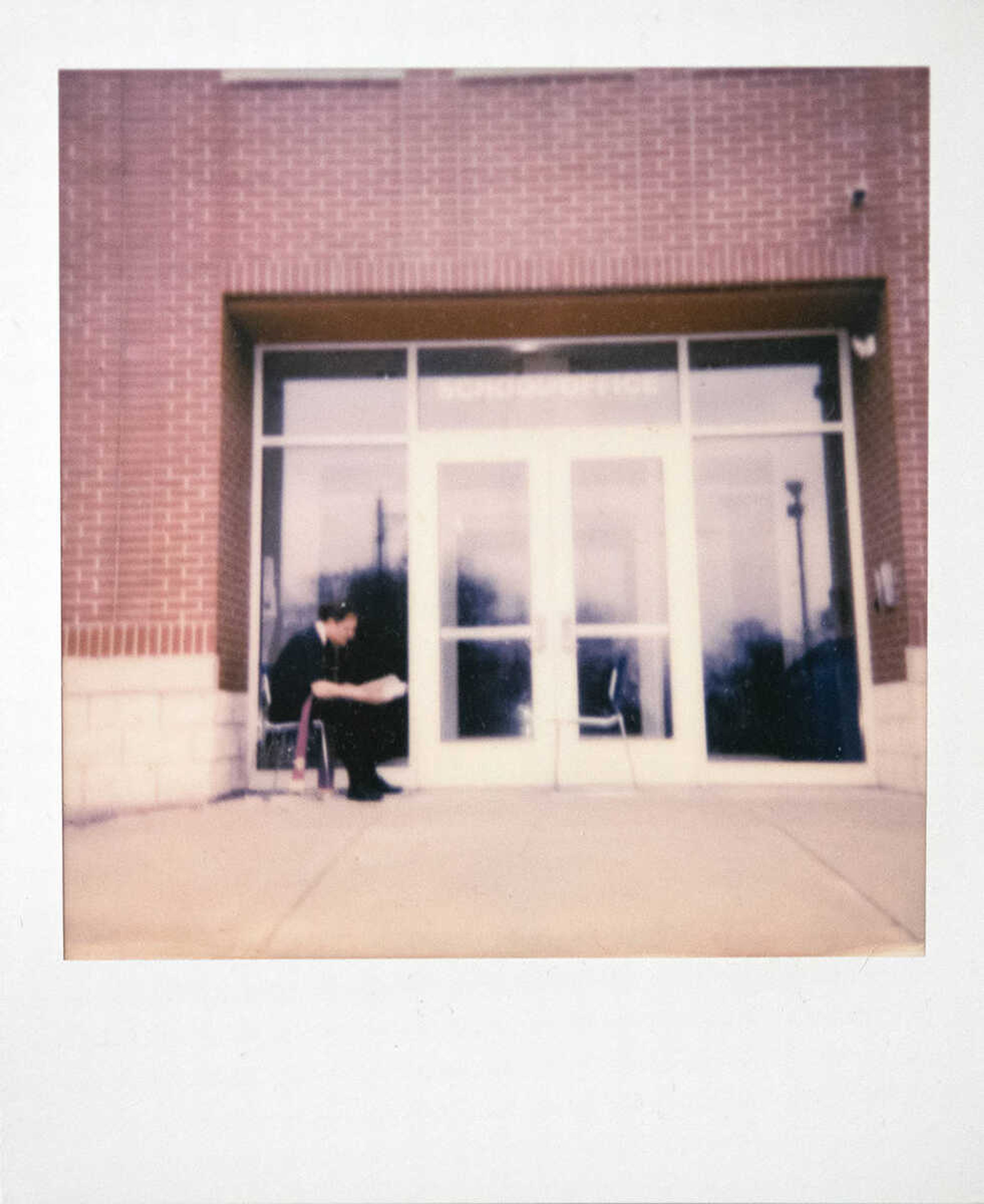 The Rev. Allan Saunders, pastor at St. Mary Cathedral, reads a book while available to hear confessions Saturday, March 28, 2020, outside St. Mary Cathedral School in Cape Girardeau. Saunders, who was scheduled to be available to hear confessions from 3:15 to 4:15 p.m., said it was the normal time for the activity, but the first time doing so outside due to the COVID-19 pandemic. "We can't have churches open so we figure we can do social distancing outside," Saunders said.