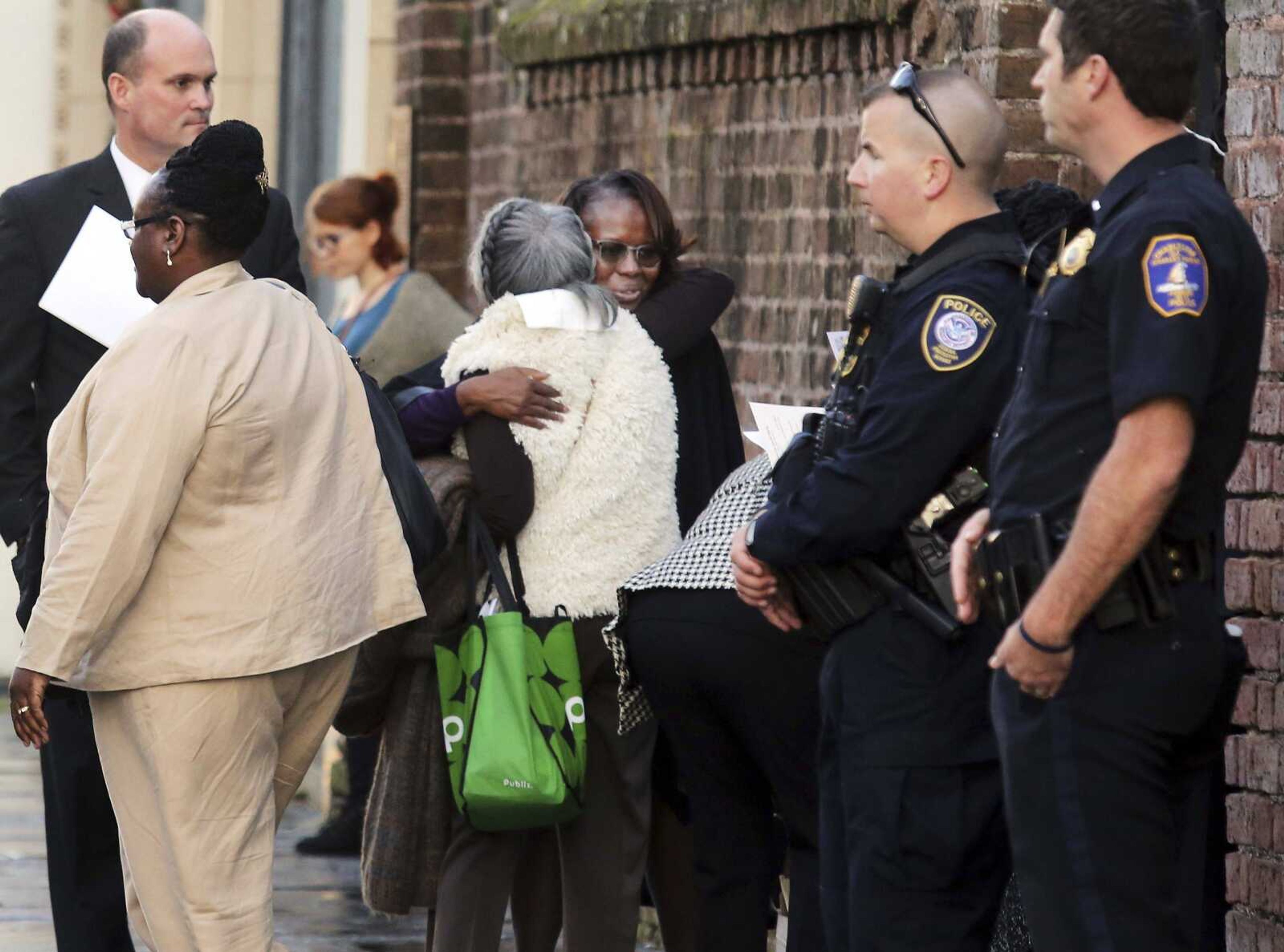 Emanuel AME shooting survivor Felicia Sanders, center, receives a hug after a church service Wednesday for the families at St. Michaels Church across from the federal courthouse in Charleston, South Carolina. Judge Richard Gergal sentenced Dylann Roof to death for the killing of nine worshipers at Emanuel AME Church in June 2015.